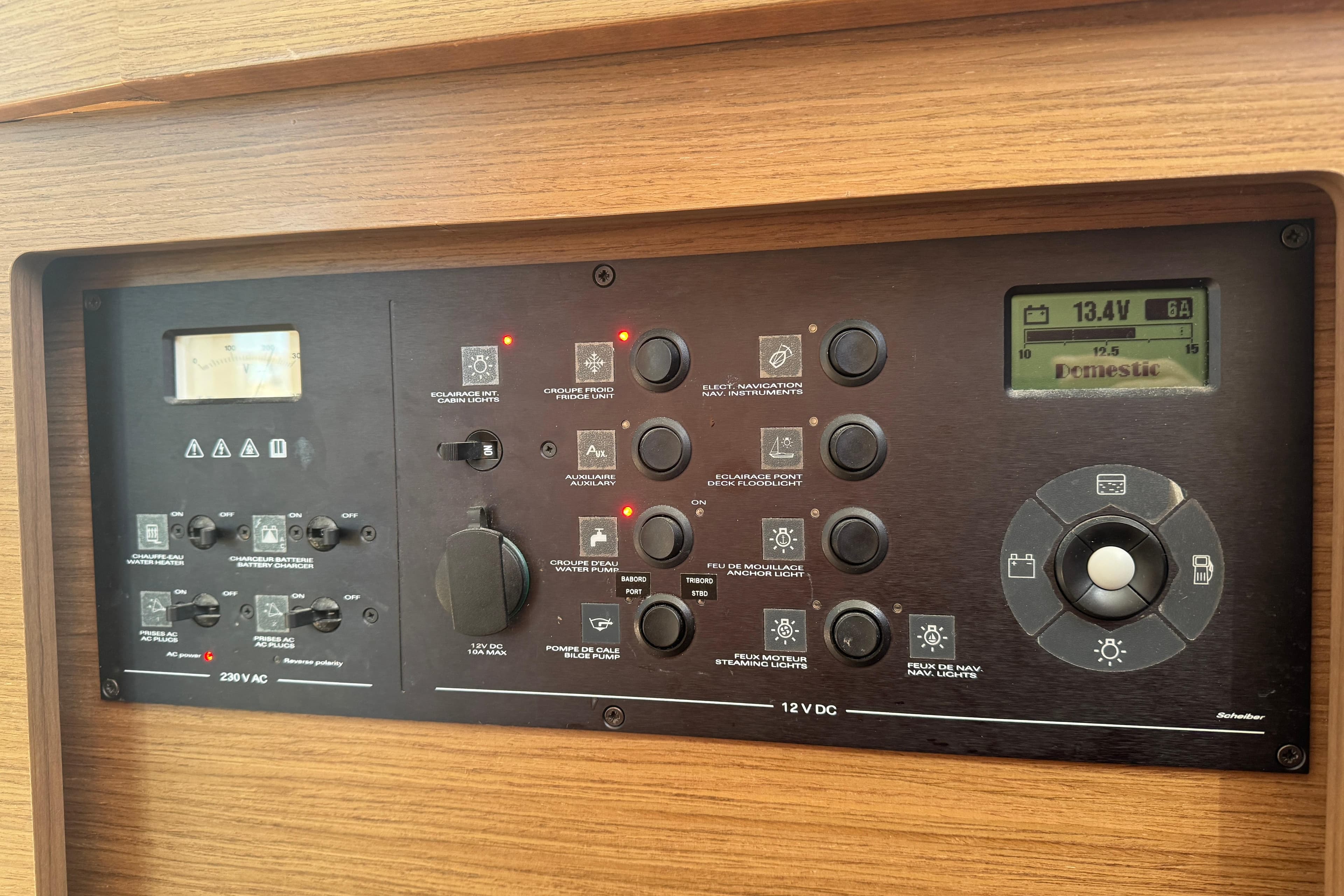 Control panel of a 2020 Lagoon 42 yacht, featuring various switches and a digital display.