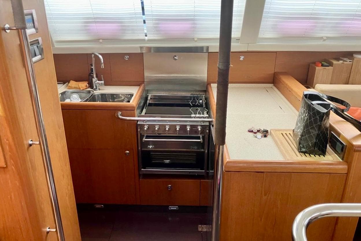 Interior of 2011 Wauquiez Pilot Saloon 55 yacht kitchen with stove and sink.
