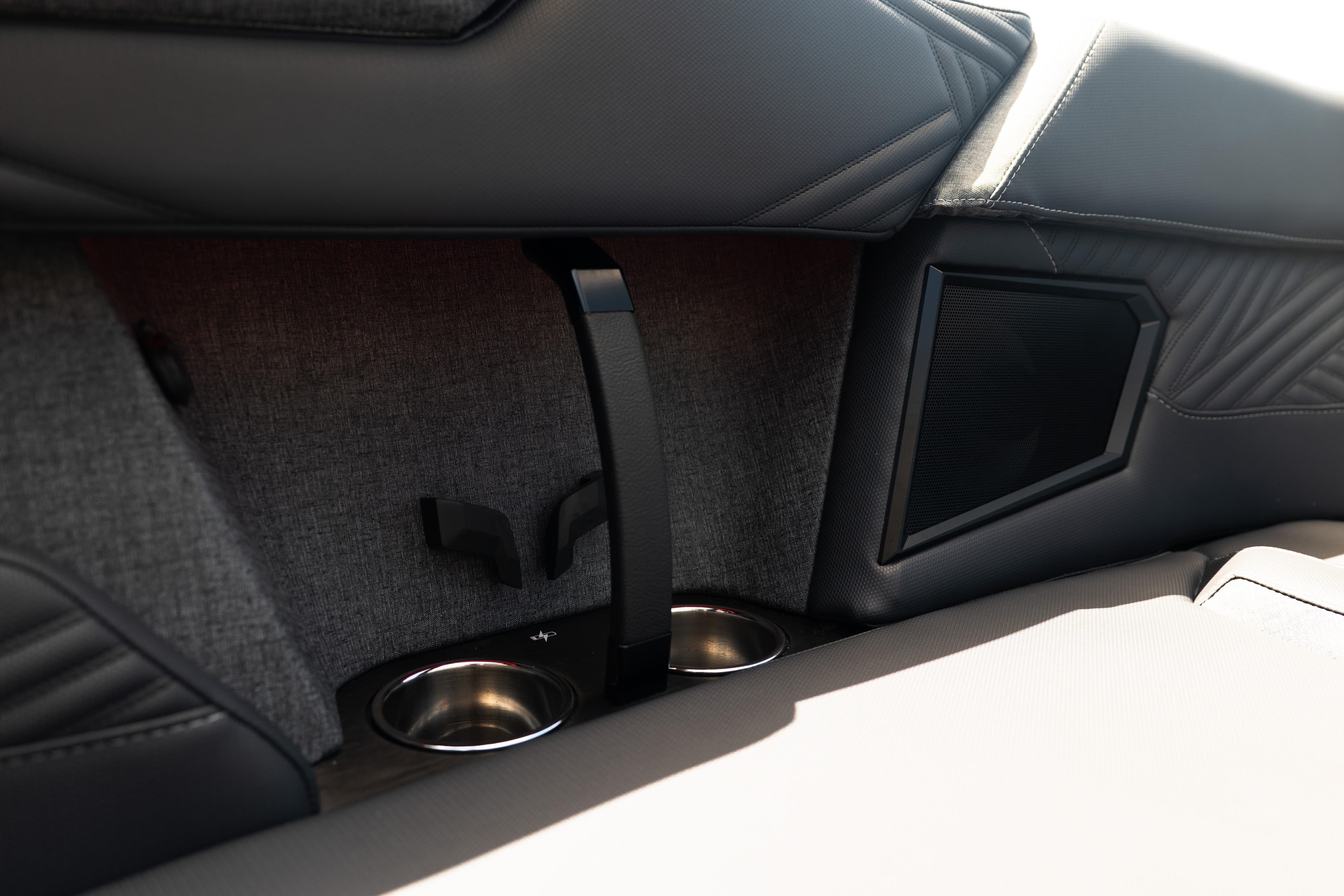 Interior of 2026 MasterCraft XStar 25 boat featuring cup holders and speaker.