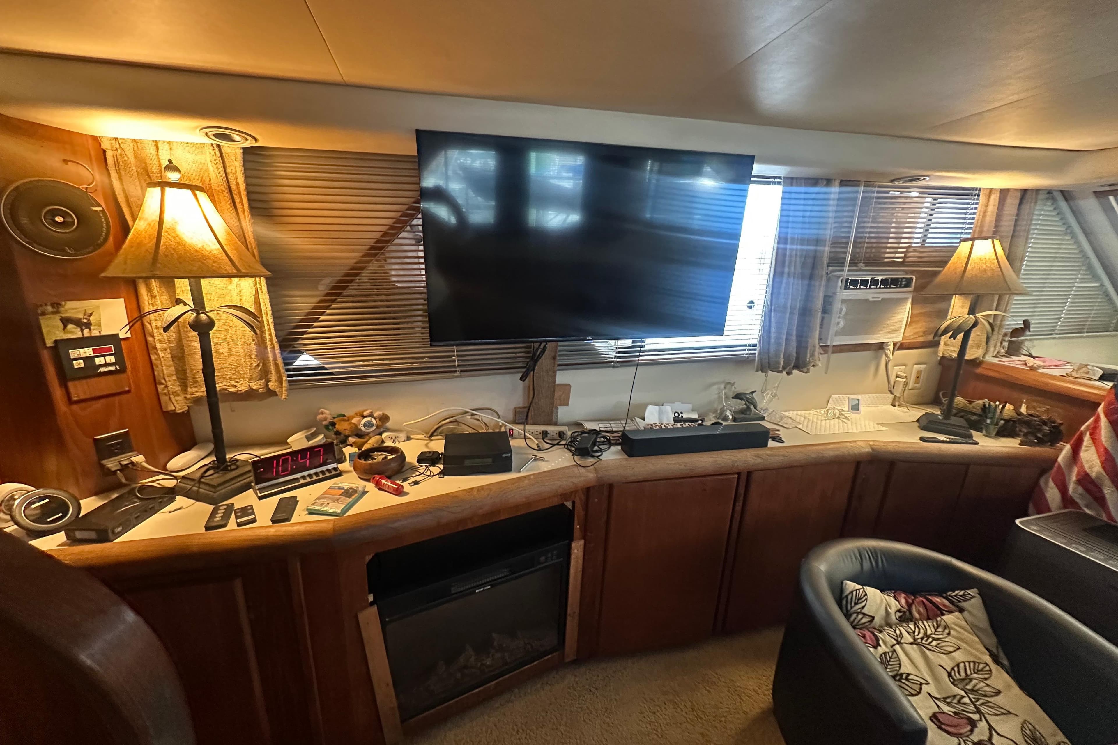 Interior of 1991 Carver Californian 48 yacht with TV, lamps, and cozy seating area.