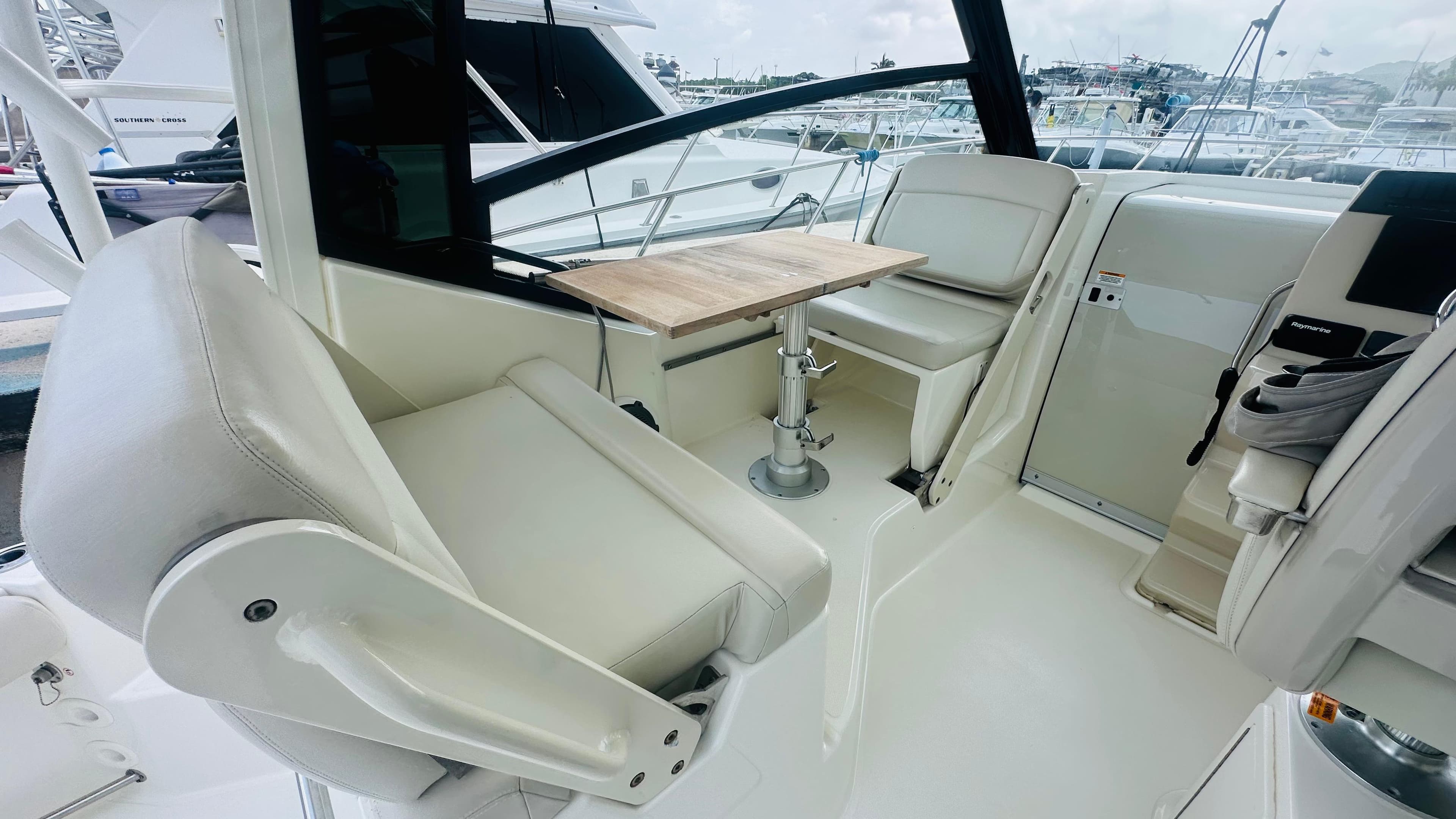 Interior of 2021 Boston Whaler 325 Conquest with seating and table.