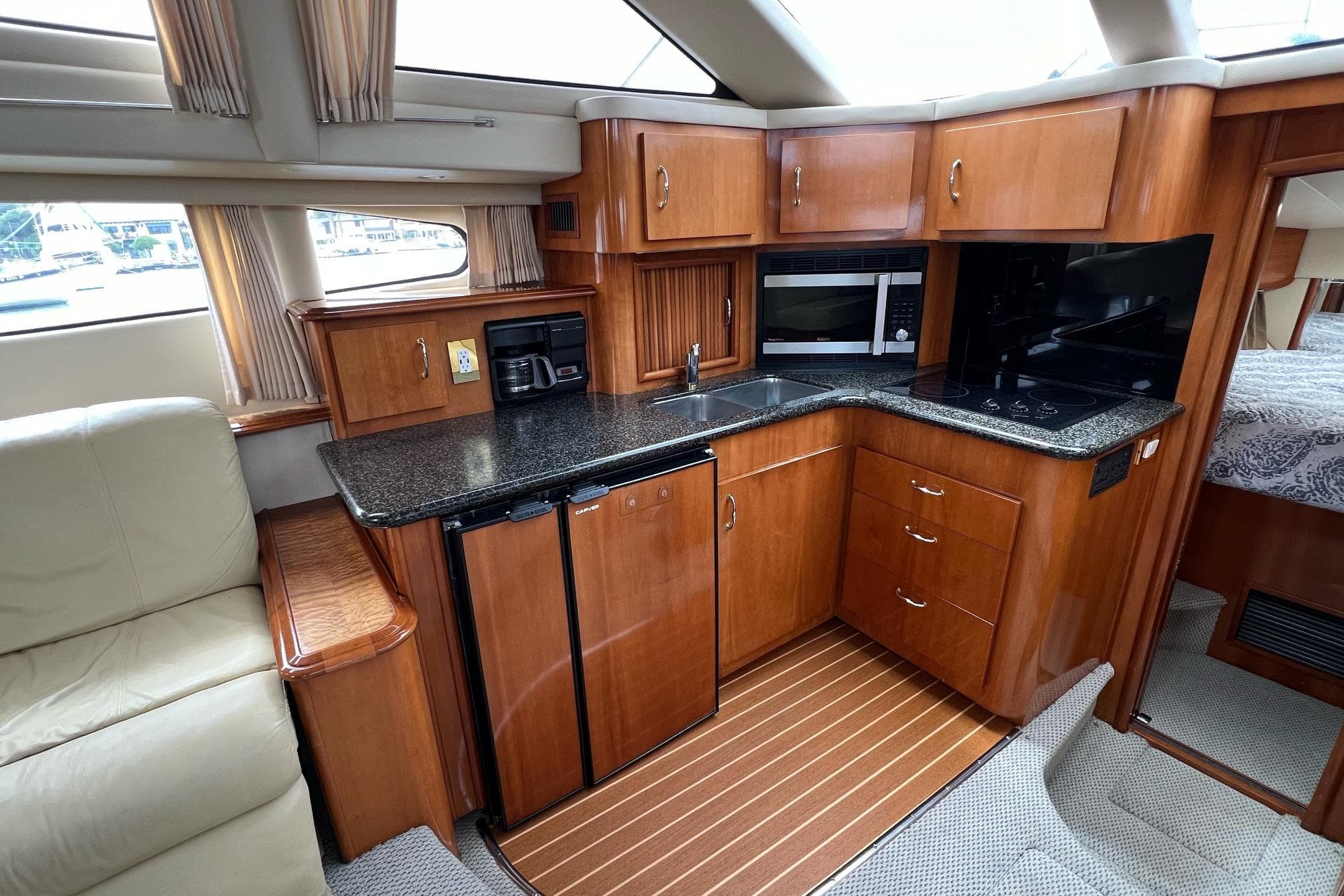 2003 Carver 444 Cockpit Motor Yacht interior with modern kitchen and wood cabinetry.