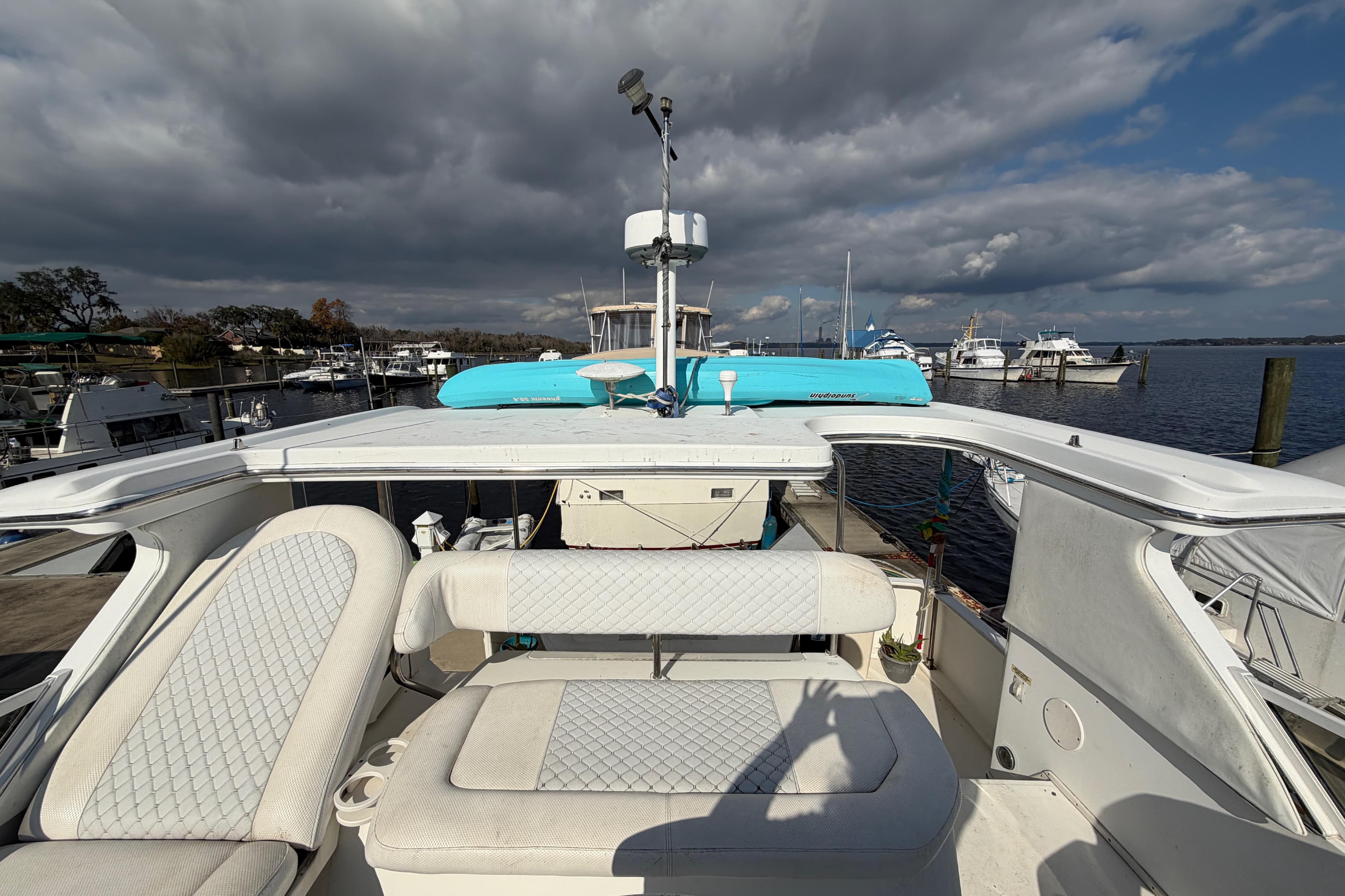 1997 Sea Ray 370 Aft Cabin yacht docked at marina under cloudy sky.