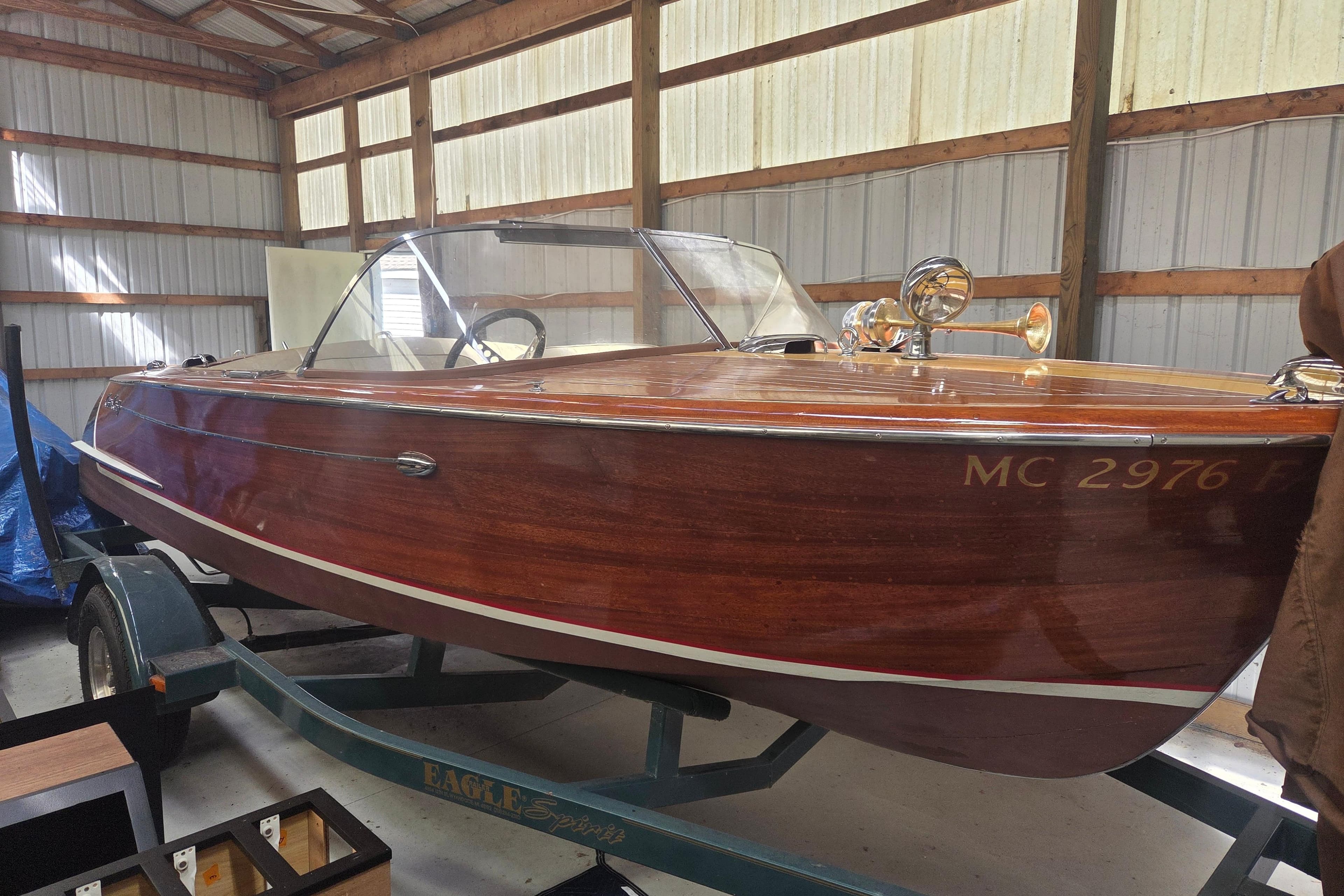 1960 Chris Craft 19 Capri wooden boat on trailer in storage shed.