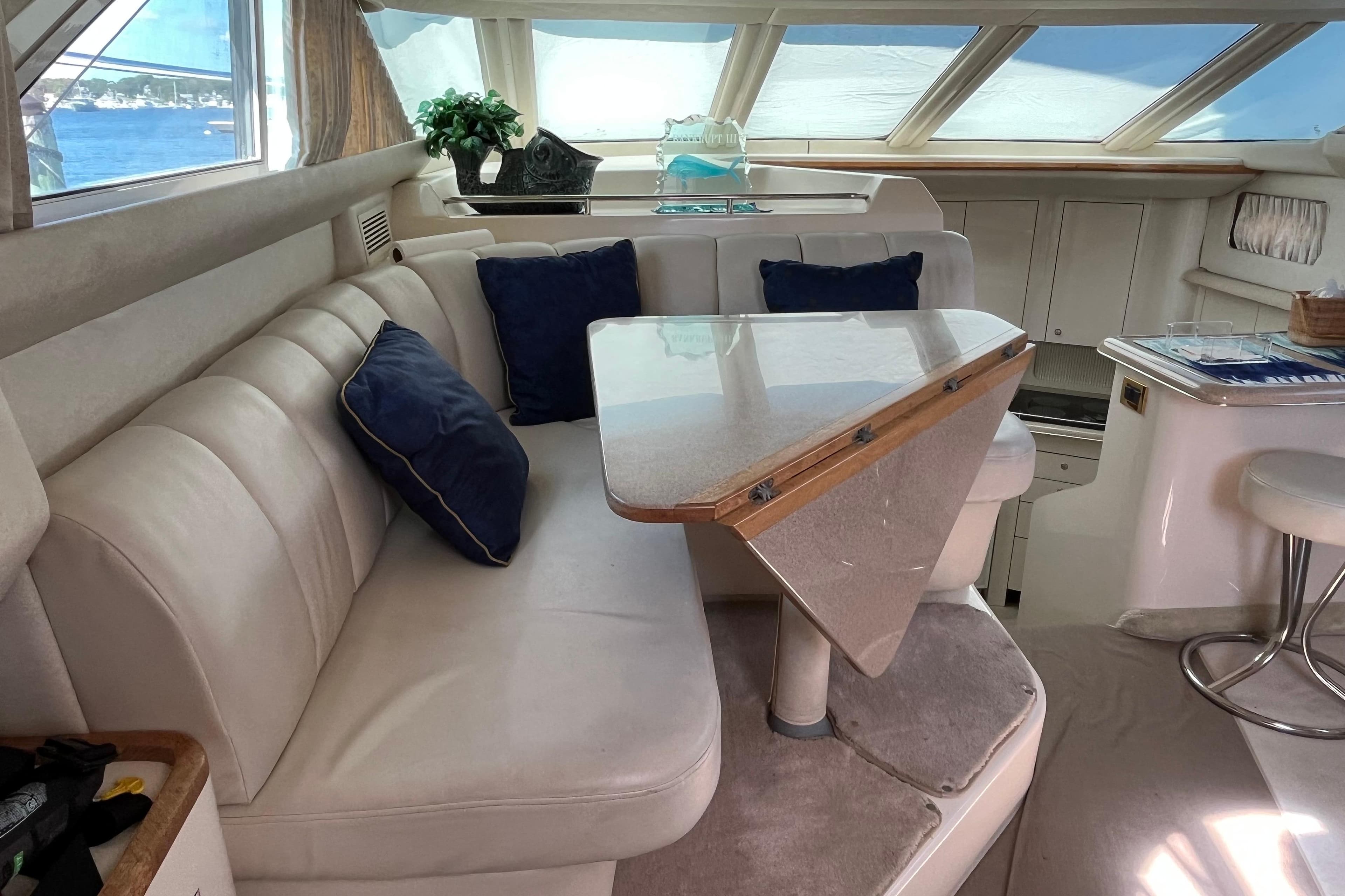 Luxurious interior of 1997 Sea Ray 420 Aft Cabin yacht with plush seating and elegant decor.
