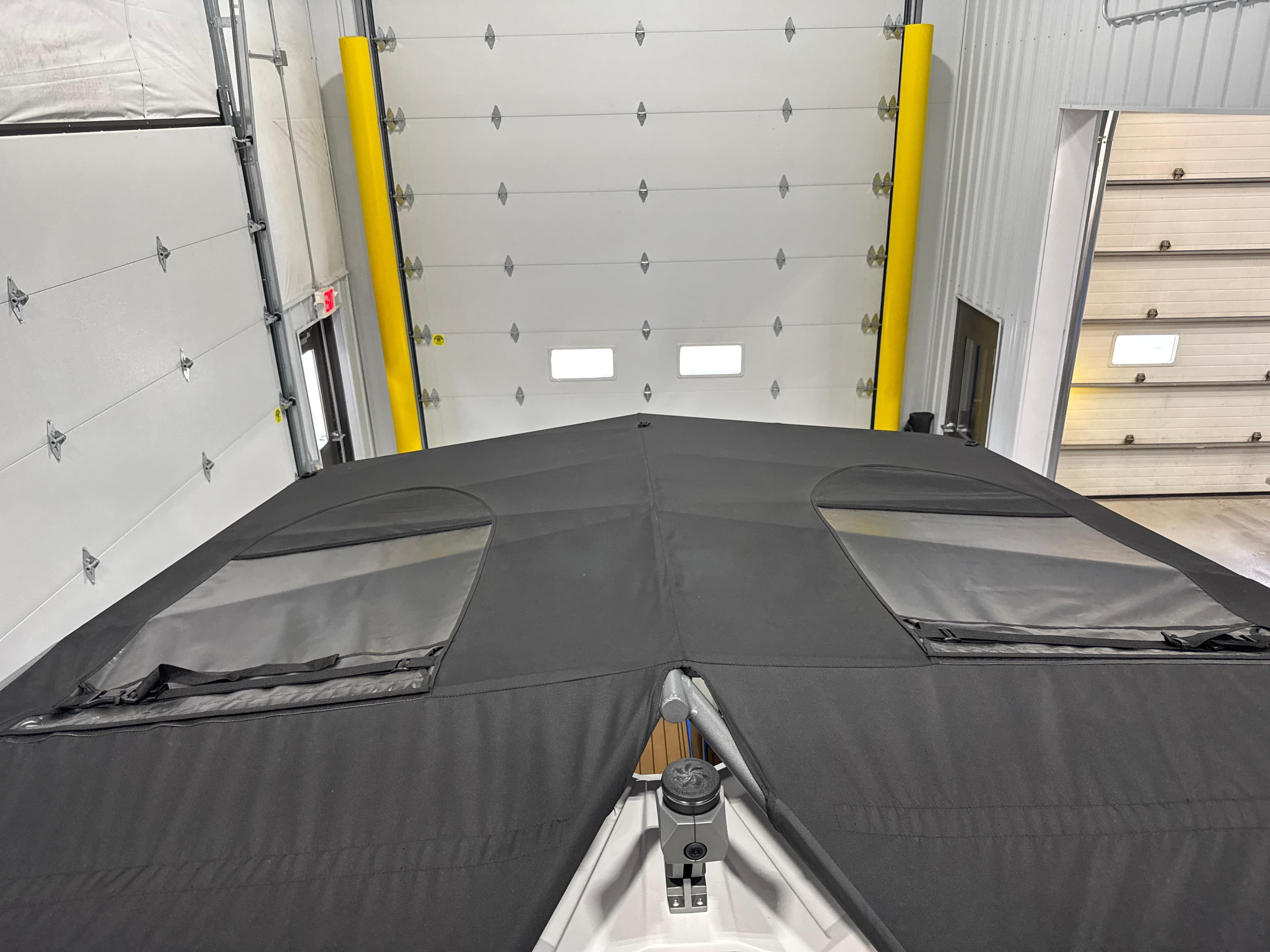 2025 Nautique Super Air Nautique S23 boat covered in a garage.