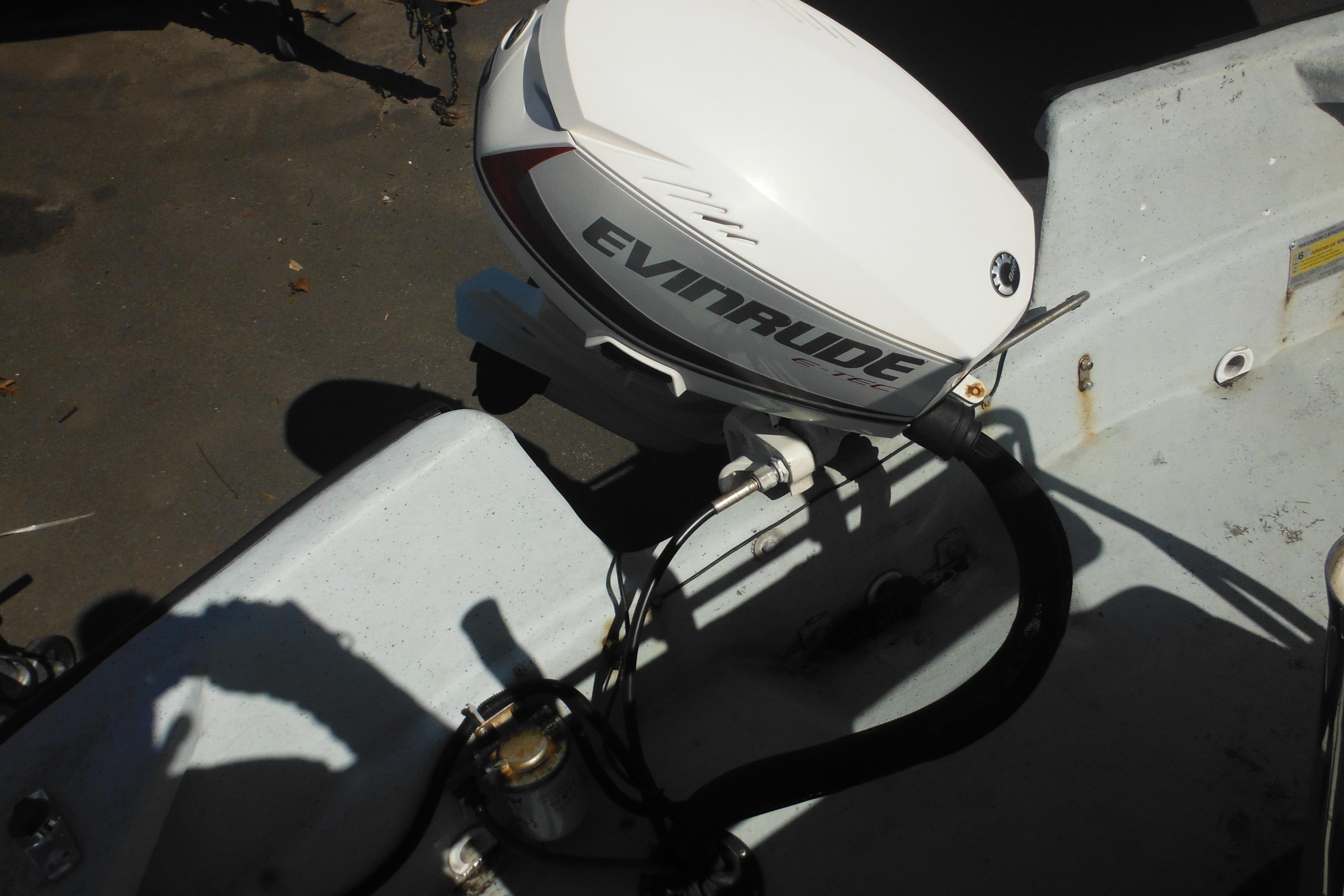 1999 Maritime Skiff 1690 with Evinrude outboard motor, close-up view.