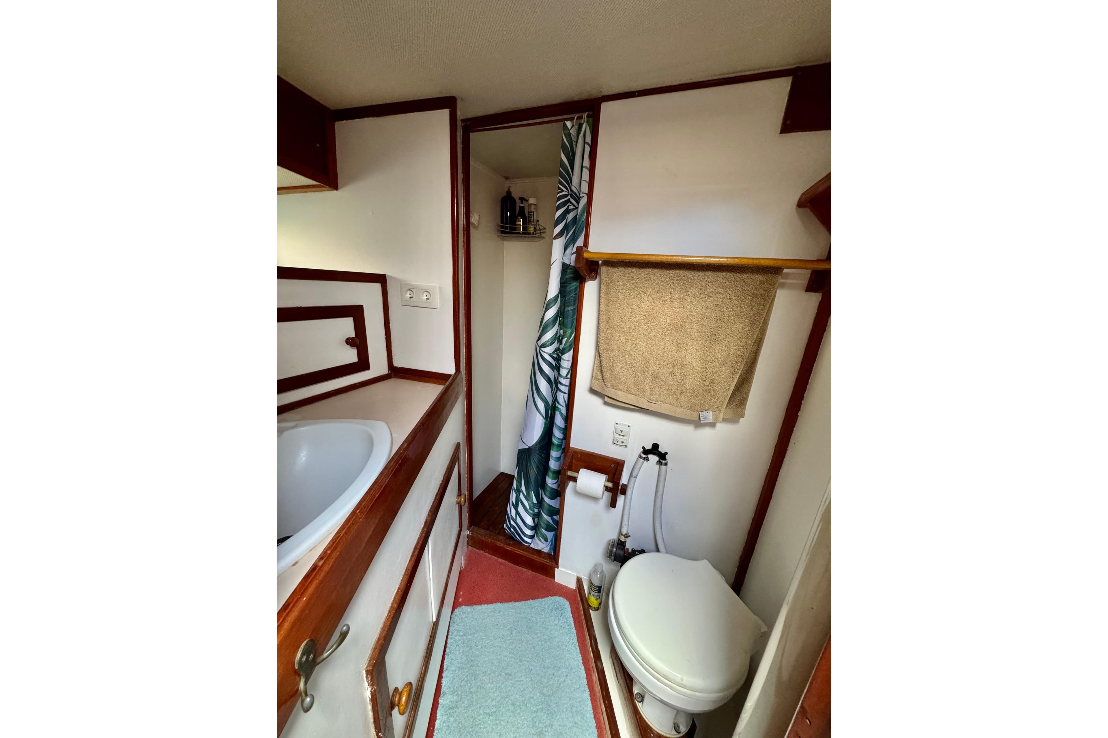 Bathroom interior of 1988 Irwin 52 yacht, featuring toilet, sink, and shower area.