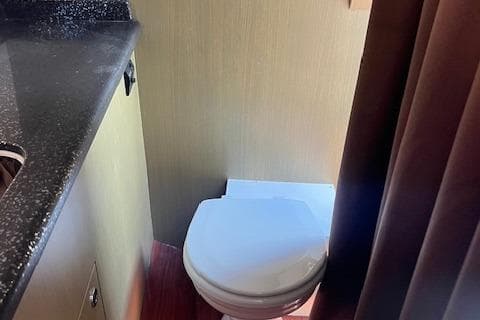 Compact bathroom in 2024 Bracewell 25 model with modern fixtures.