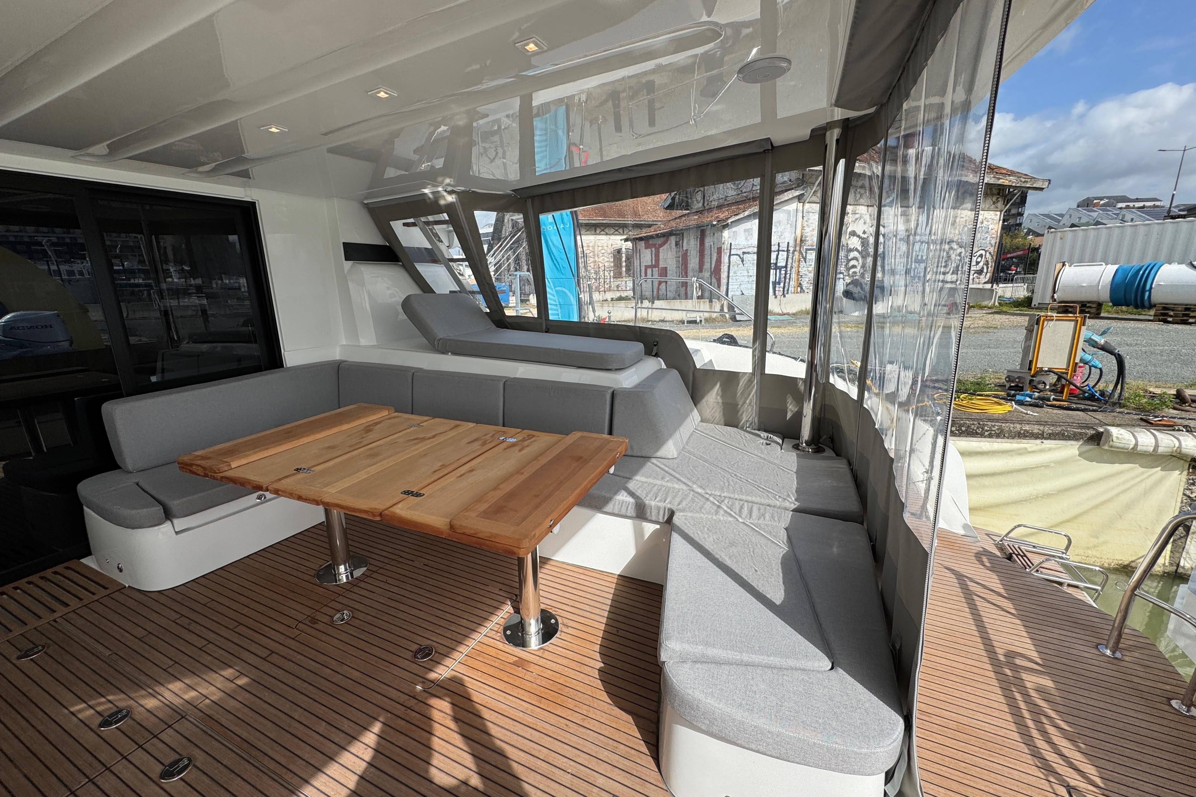 Luxurious 2026 Lagoon 55 yacht interior with elegant seating and wooden table.