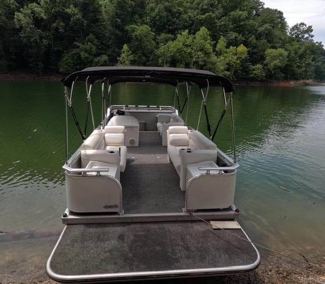 1988 Sun Tracker PARTY BARGE pontoon boat on a serene lake.