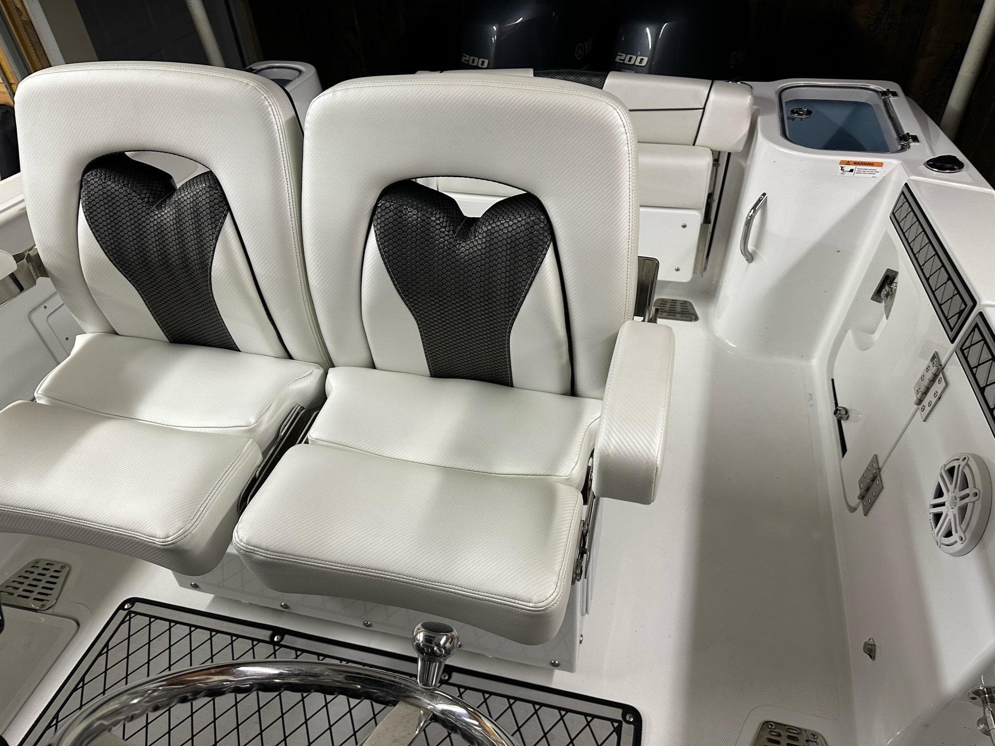 2021 Wellcraft 262 Fisherman boat interior with dual white seats and modern design.
