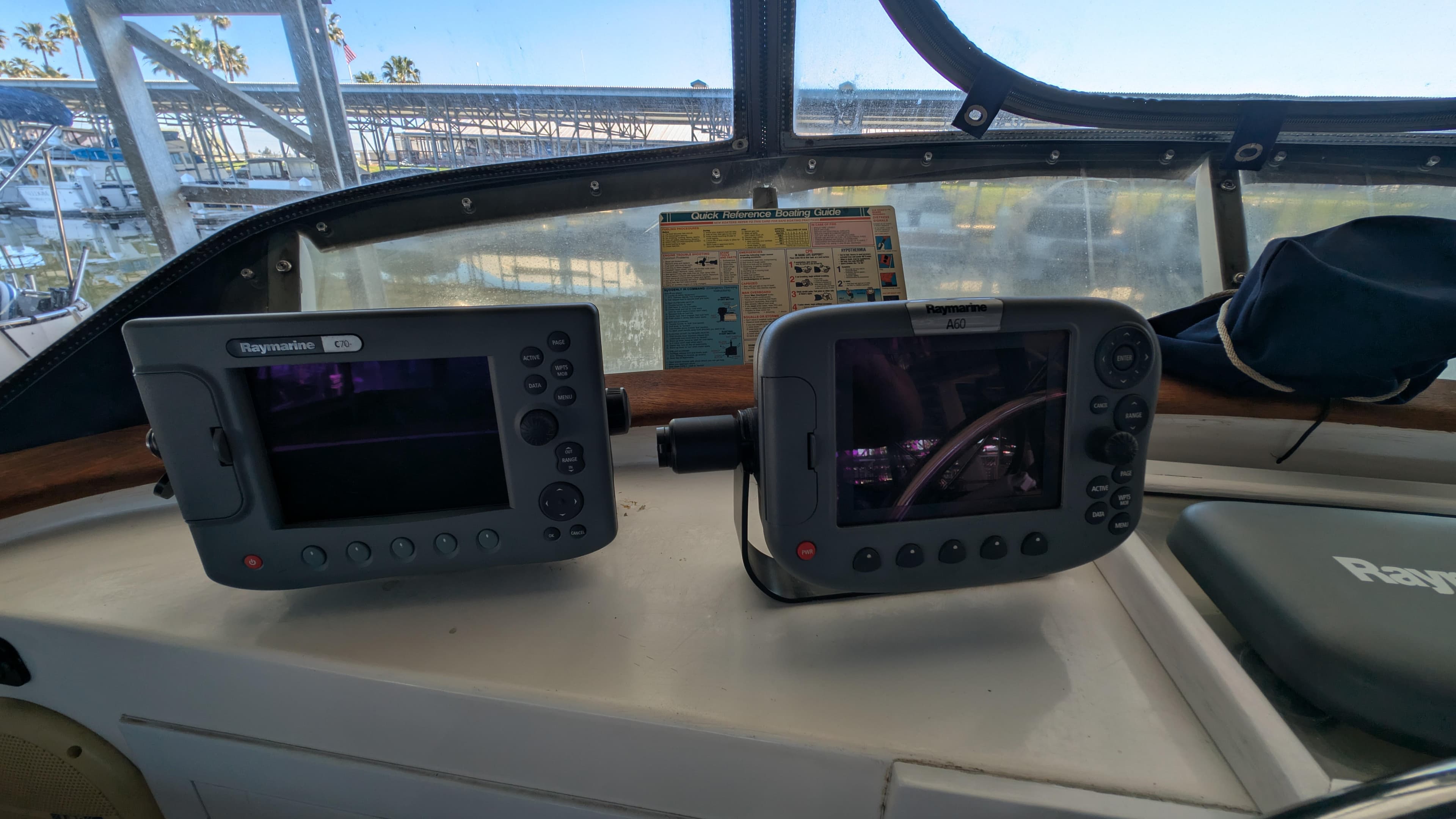 Boat cockpit with navigation equipment, featuring Raymarine displays on a 1982 Monk 36 model.