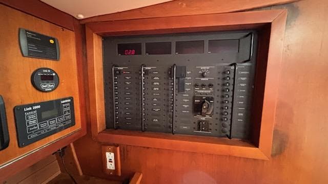 Electrical panel inside a 2003 J Boats J/46 sailboat, featuring various switches and controls.