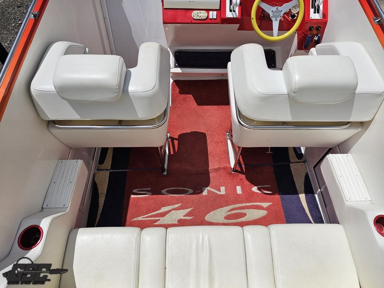Interior of a 2004 Sonic USA 45SS boat with white seating and red accents.