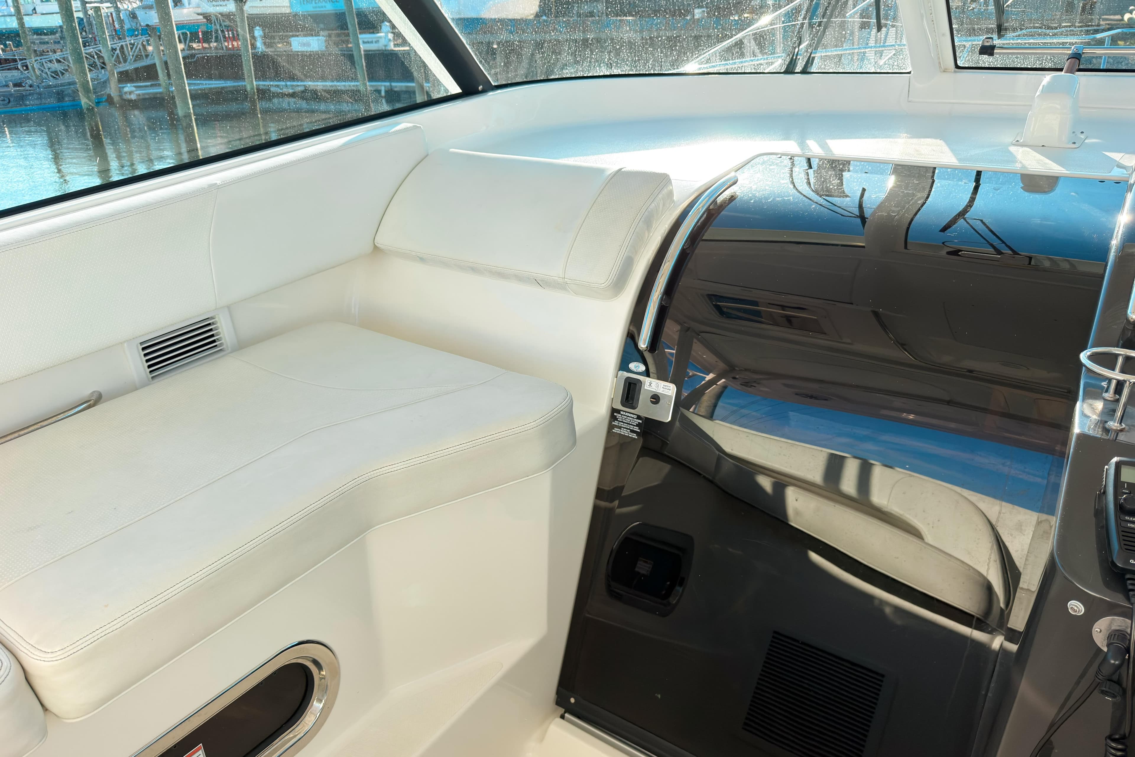 Interior of 2021 Pursuit OS 385 Offshore boat with white seating and sleek design.