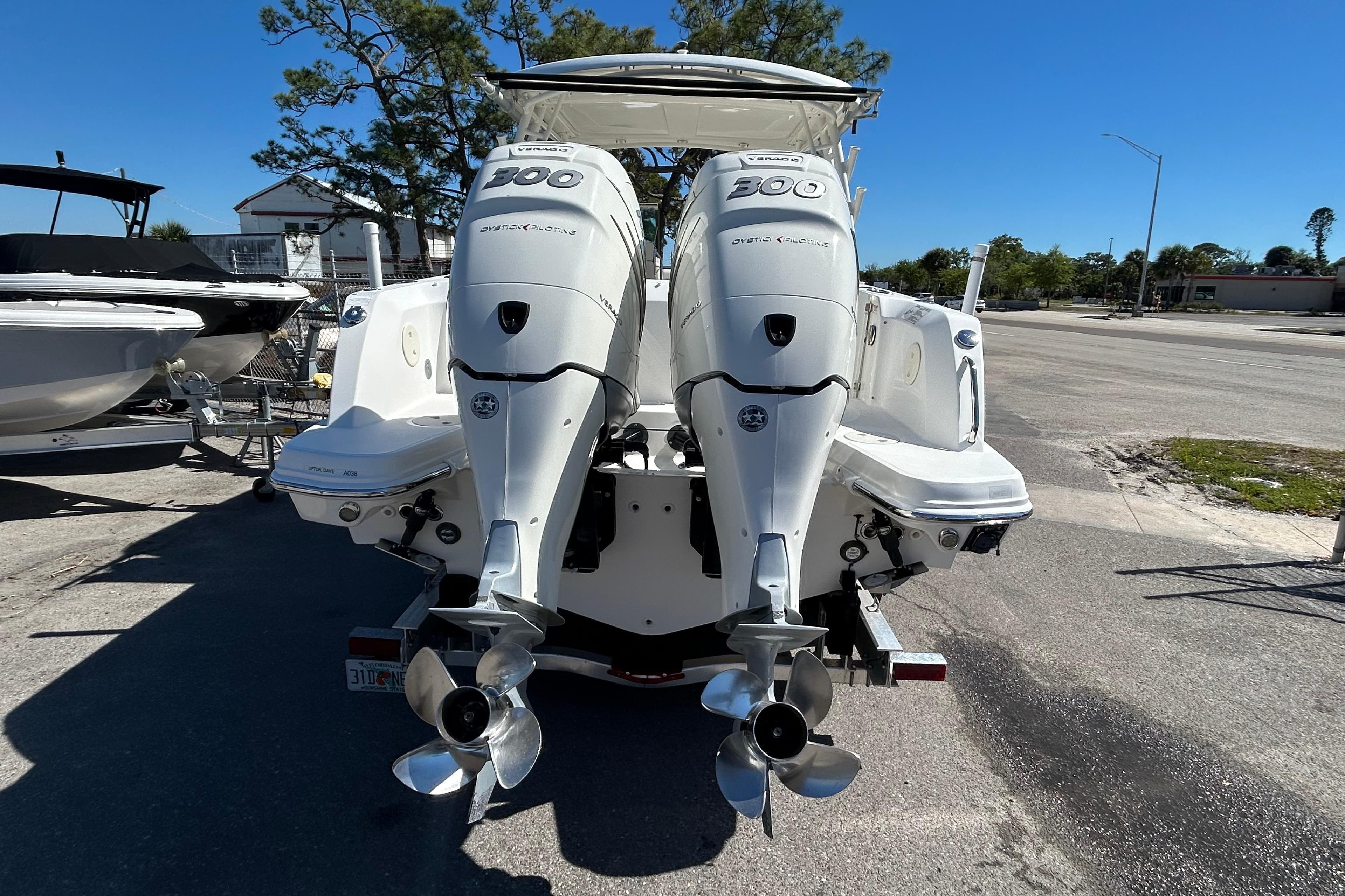 2018 Boston Whaler 270 Vantage with twin 300 horsepower engines, parked on a sunny day.