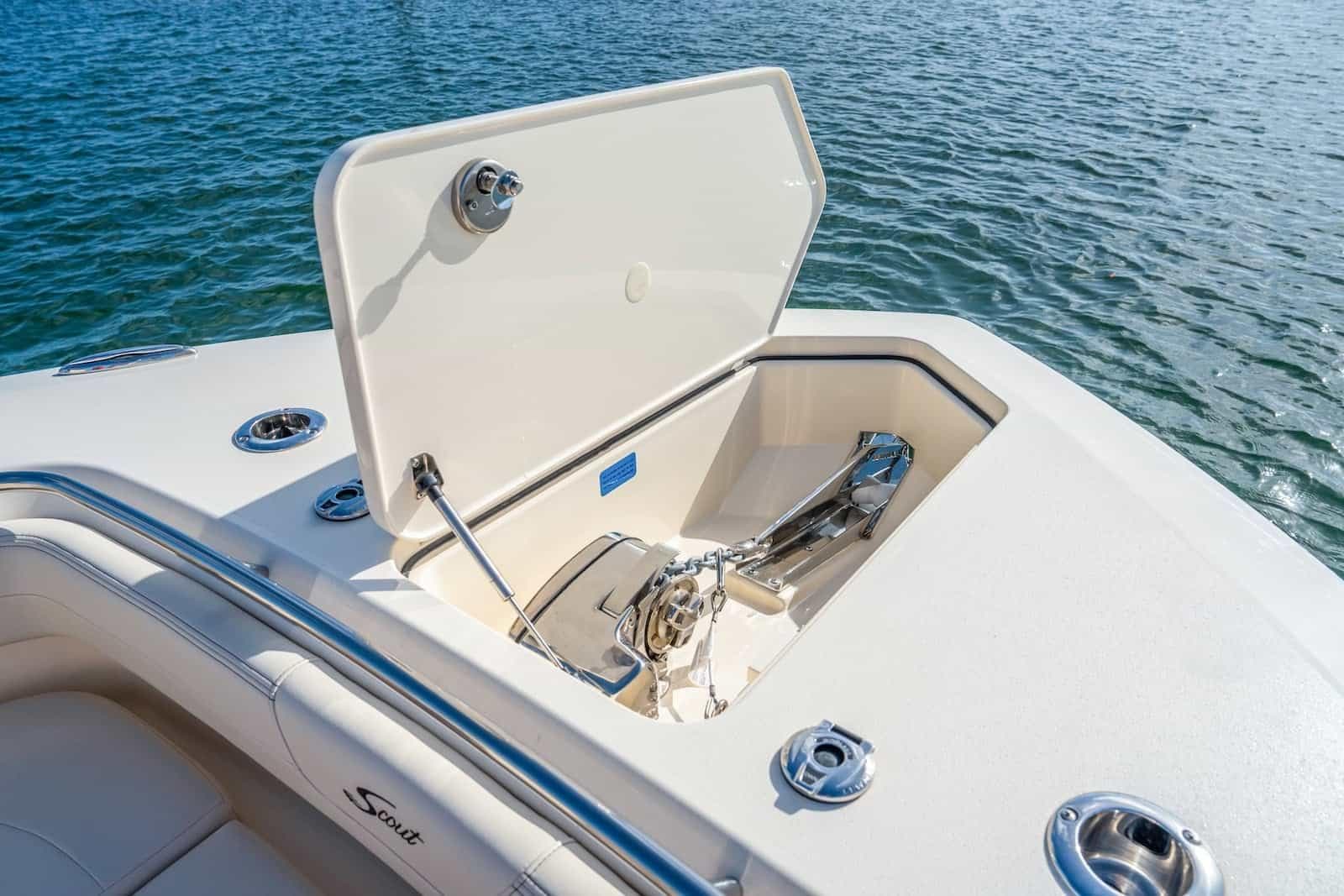 2026 Scout 288 LXF boat anchor compartment open on calm water.