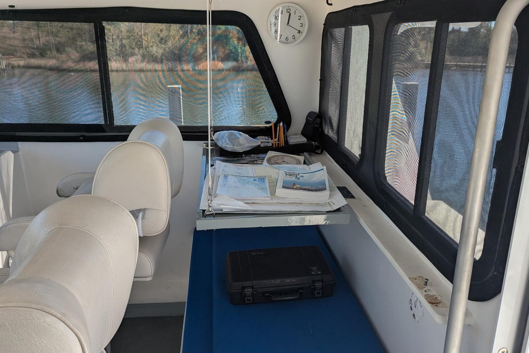 Interior of 2019 Newton 53 dive boat with navigation charts and equipment.