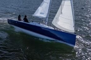 2025 J Boats J 7 sailing on open water with two passengers.