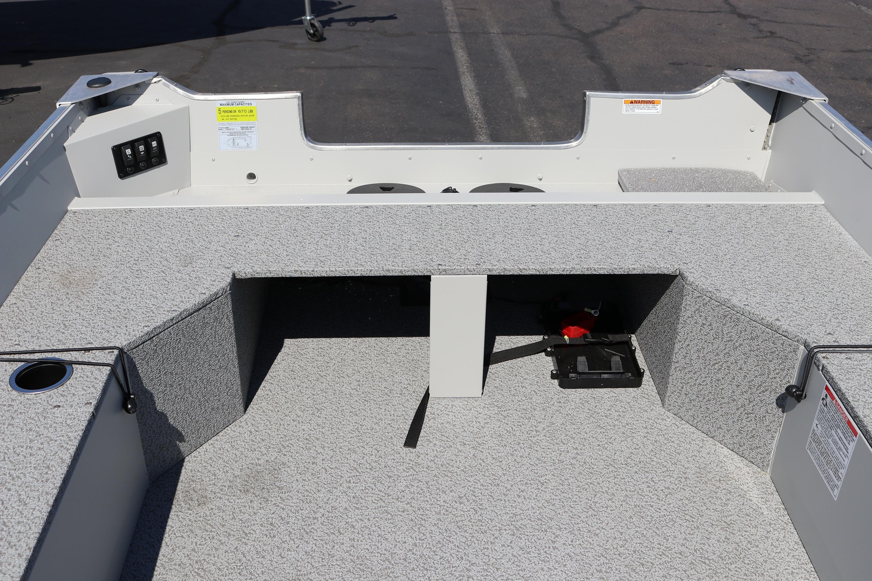 2025 Smoker Craft Angler 16 XL TL boat interior with gray carpeted seating and storage.