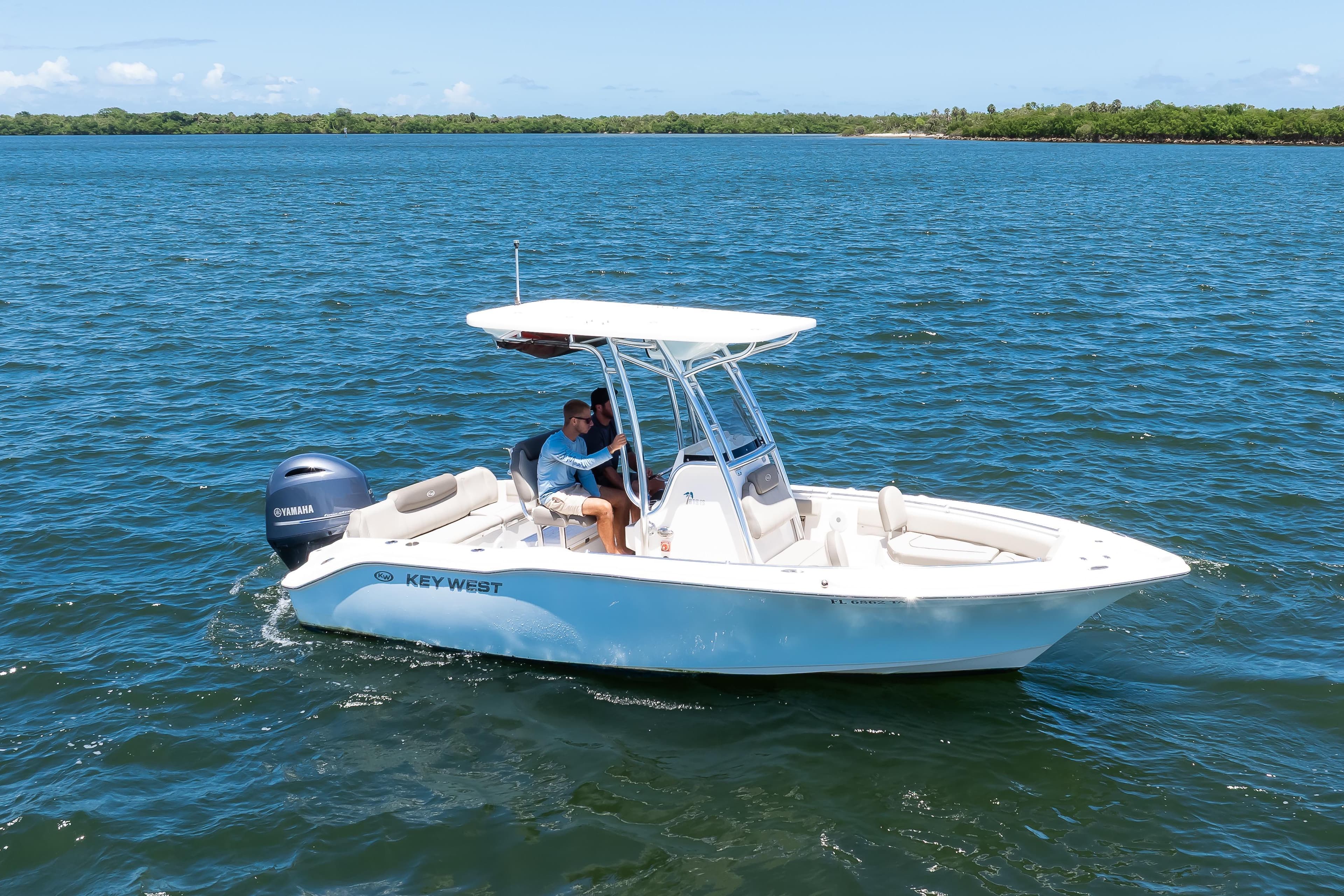 2021 Key West 219 FS boat cruising on open water under clear skies.