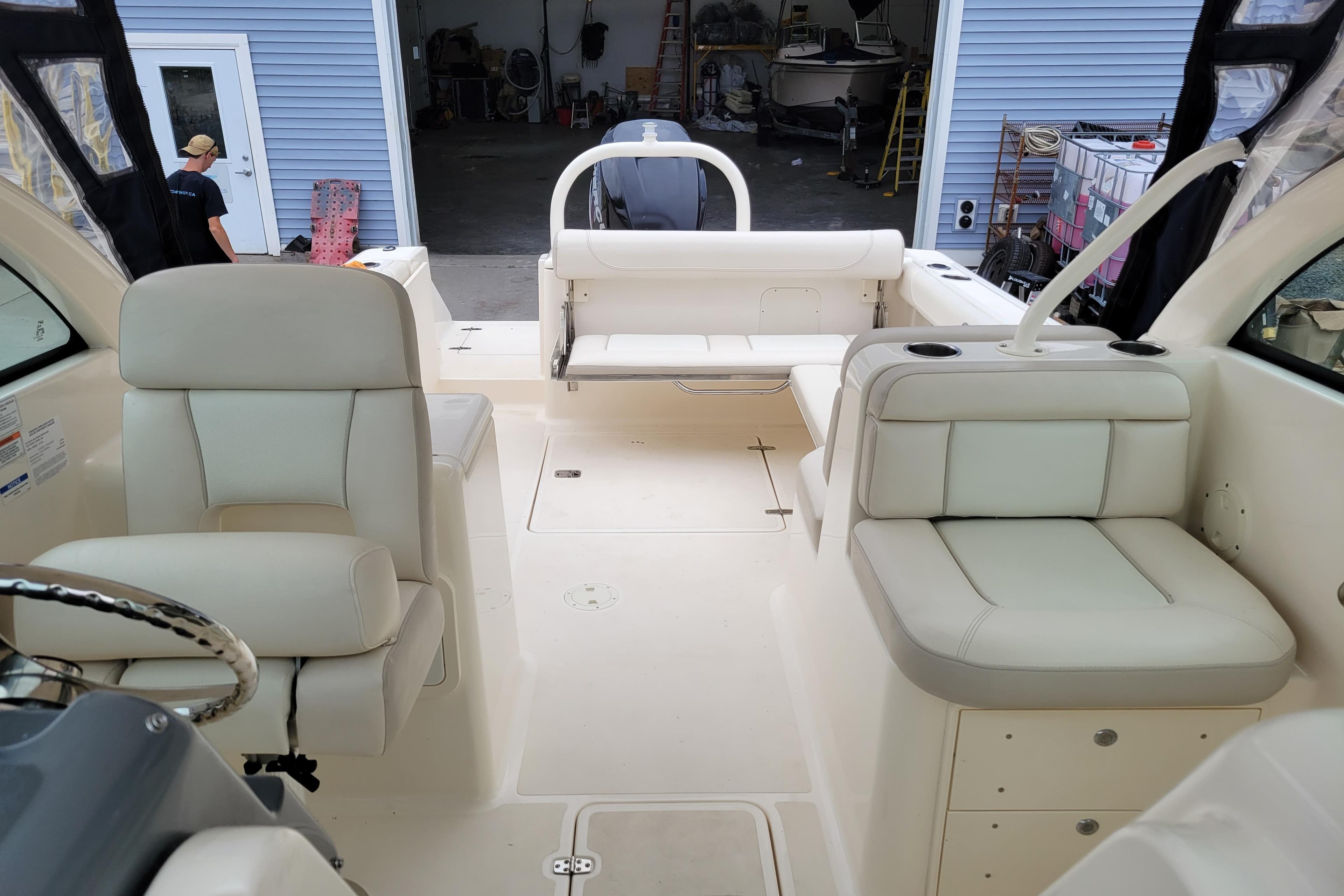 2011 Pursuit DC 265 Dual Console boat interior with white seating and spacious layout.