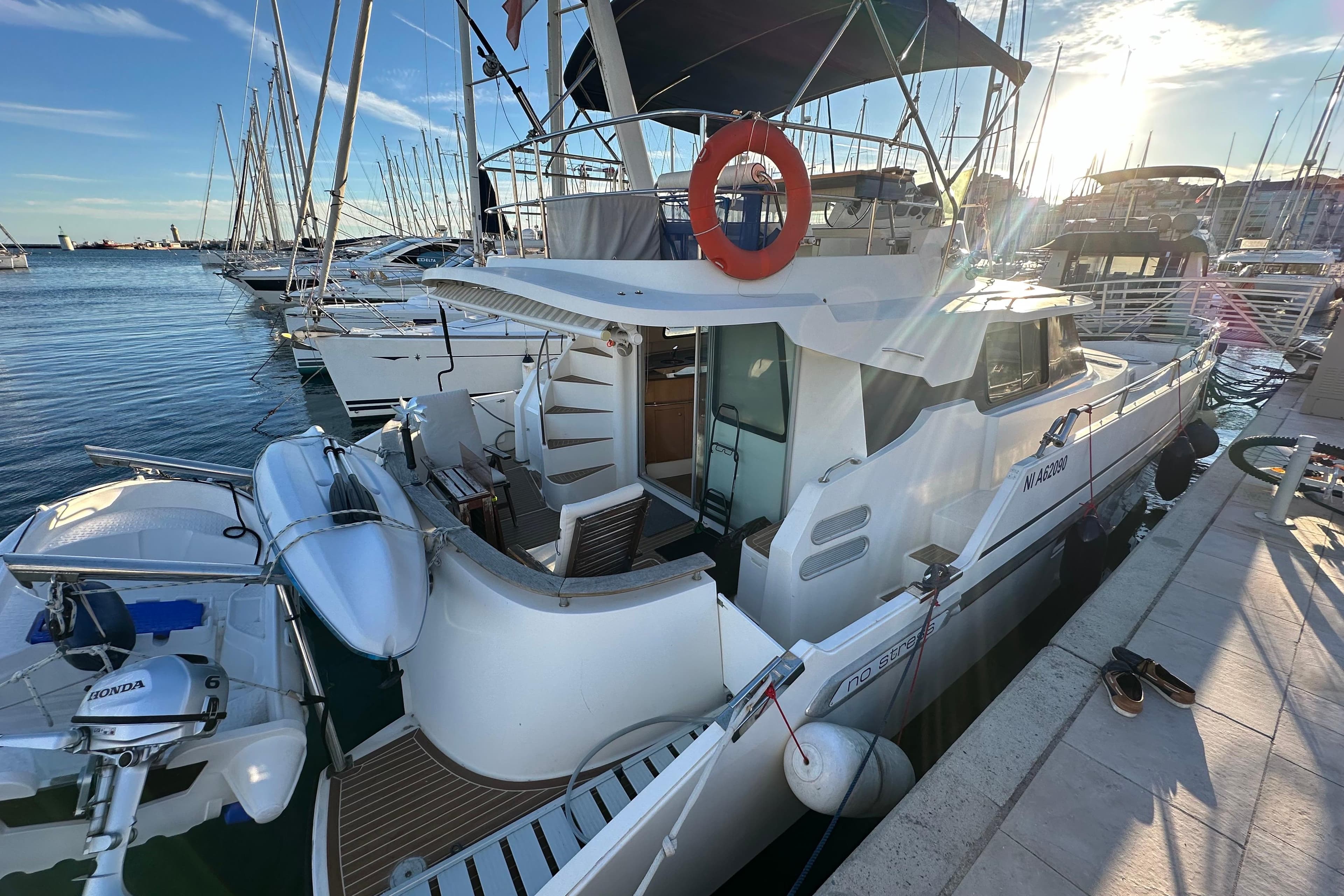 1999 Fountaine Pajot Maryland 37 yacht docked at marina, sunny day, lifebuoy visible.