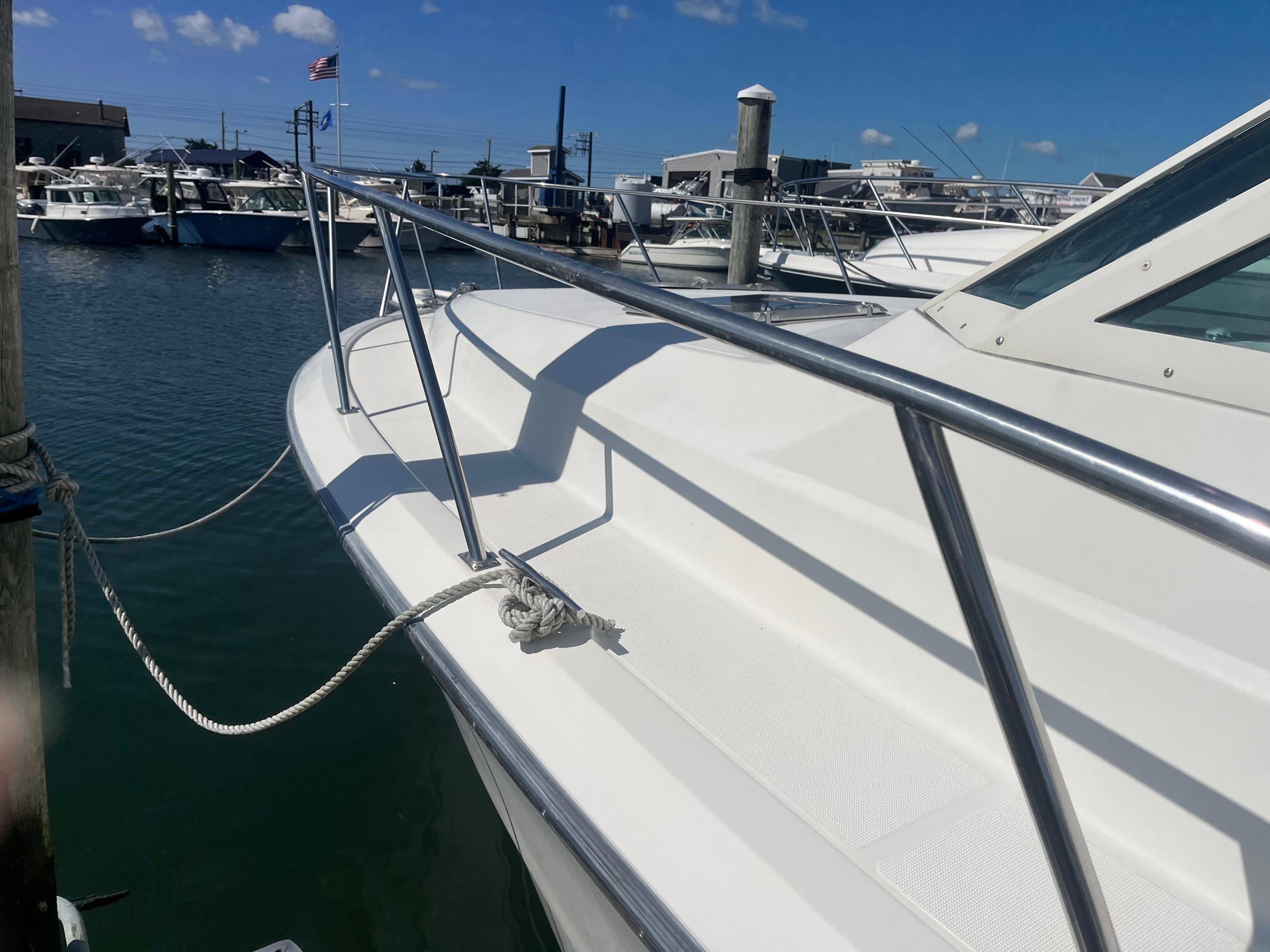1989 Tiara Yachts 33OPEN docked, showcasing sleek white deck and stainless steel railings.