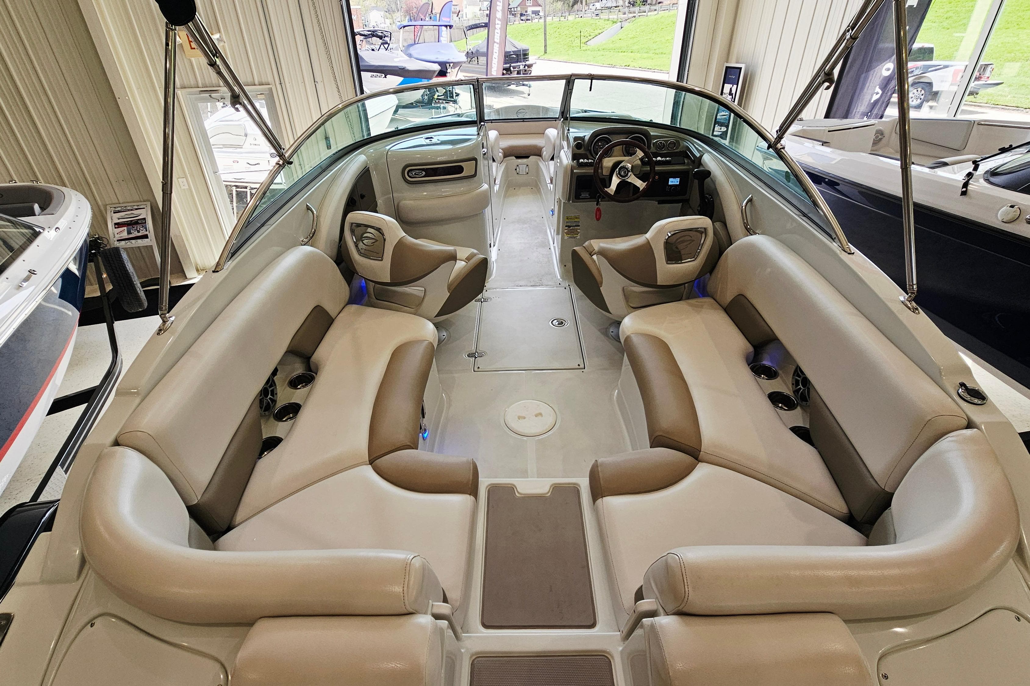 2014 Crownline 255 SS boat interior with beige seating and modern dashboard.