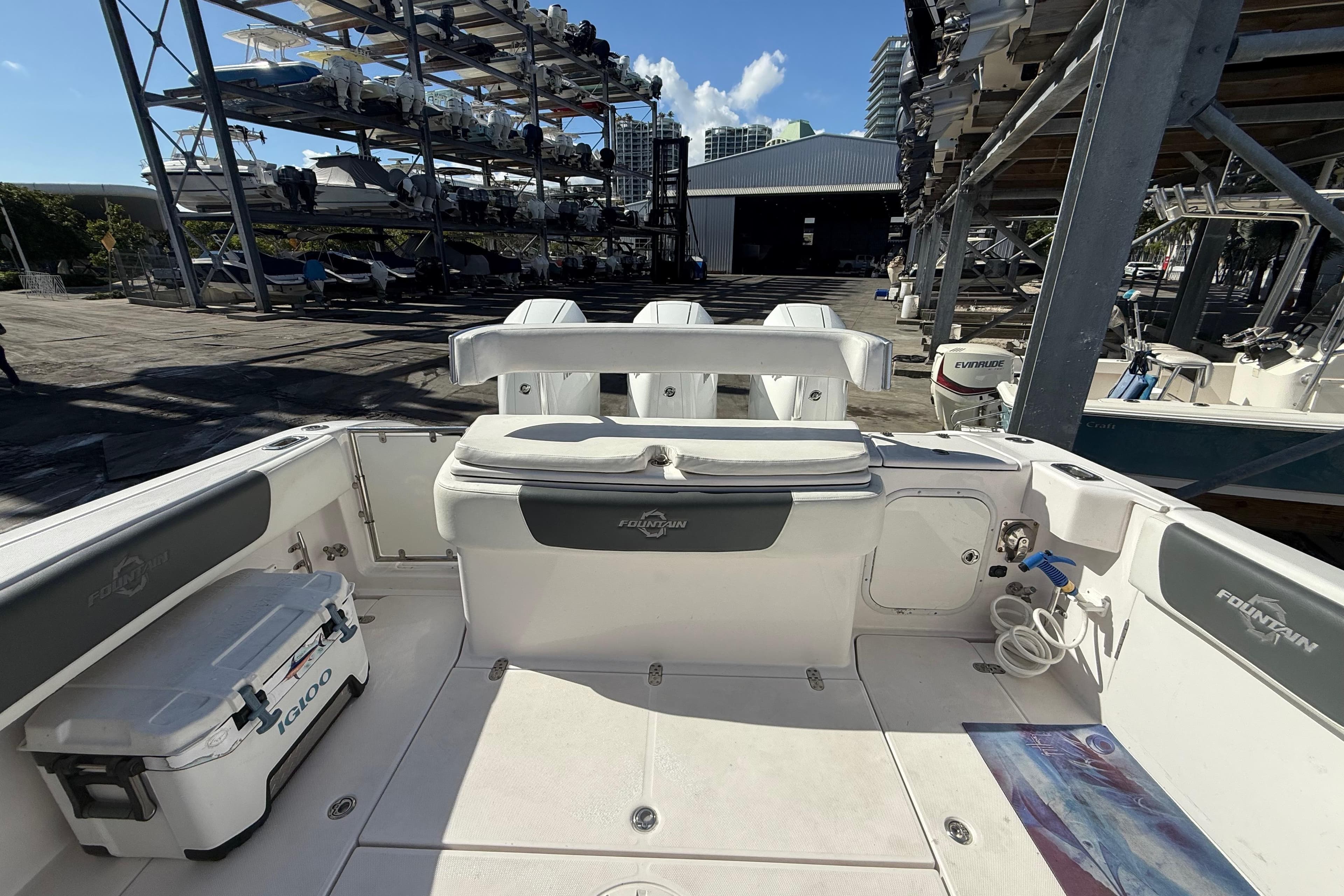 2017 Fountain 38 Sportfish Cruiser boat interior at marina with stacked boats in background.