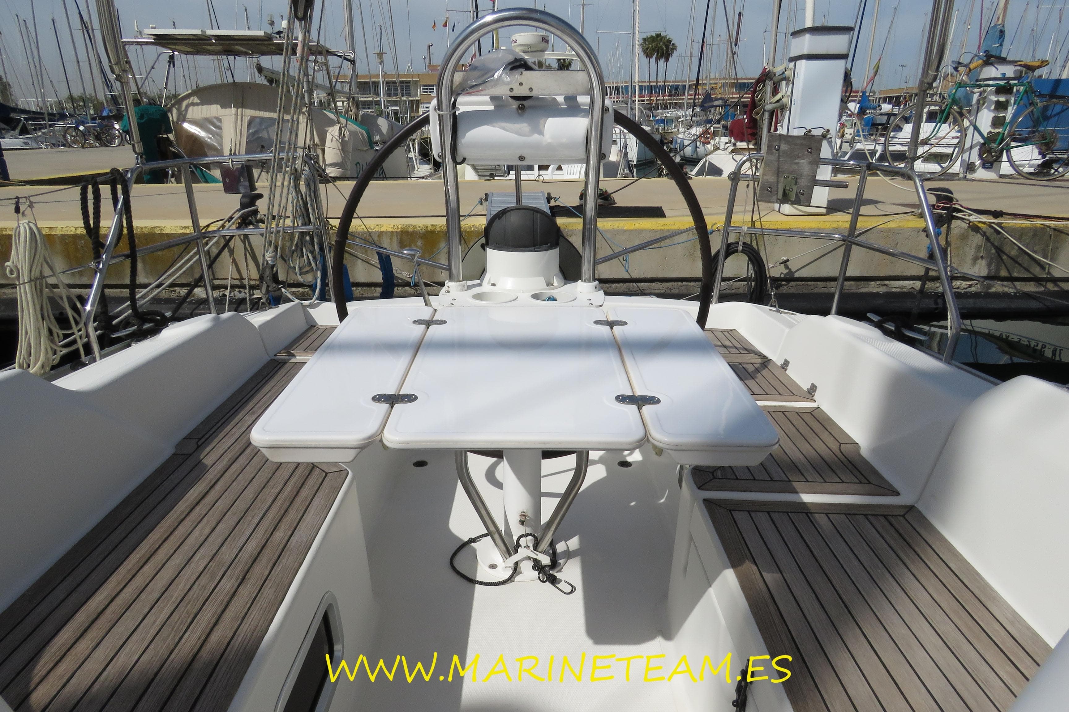 Cockpit of 2007 Hanse 342 sailboat with wooden deck and steering wheel.