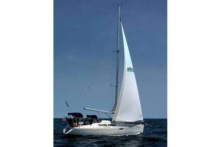 2007 Jeanneau Sun Odyssey 36i sailing on open water under clear skies.