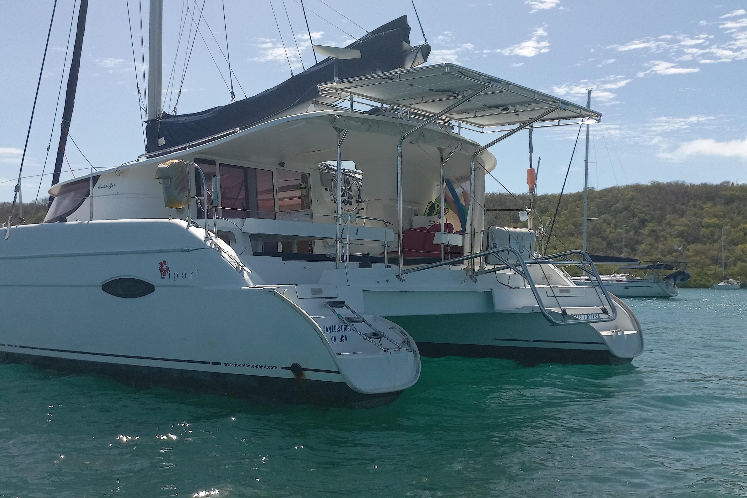 2010 Fountaine Pajot Lipari 41 catamaran anchored in clear blue water.