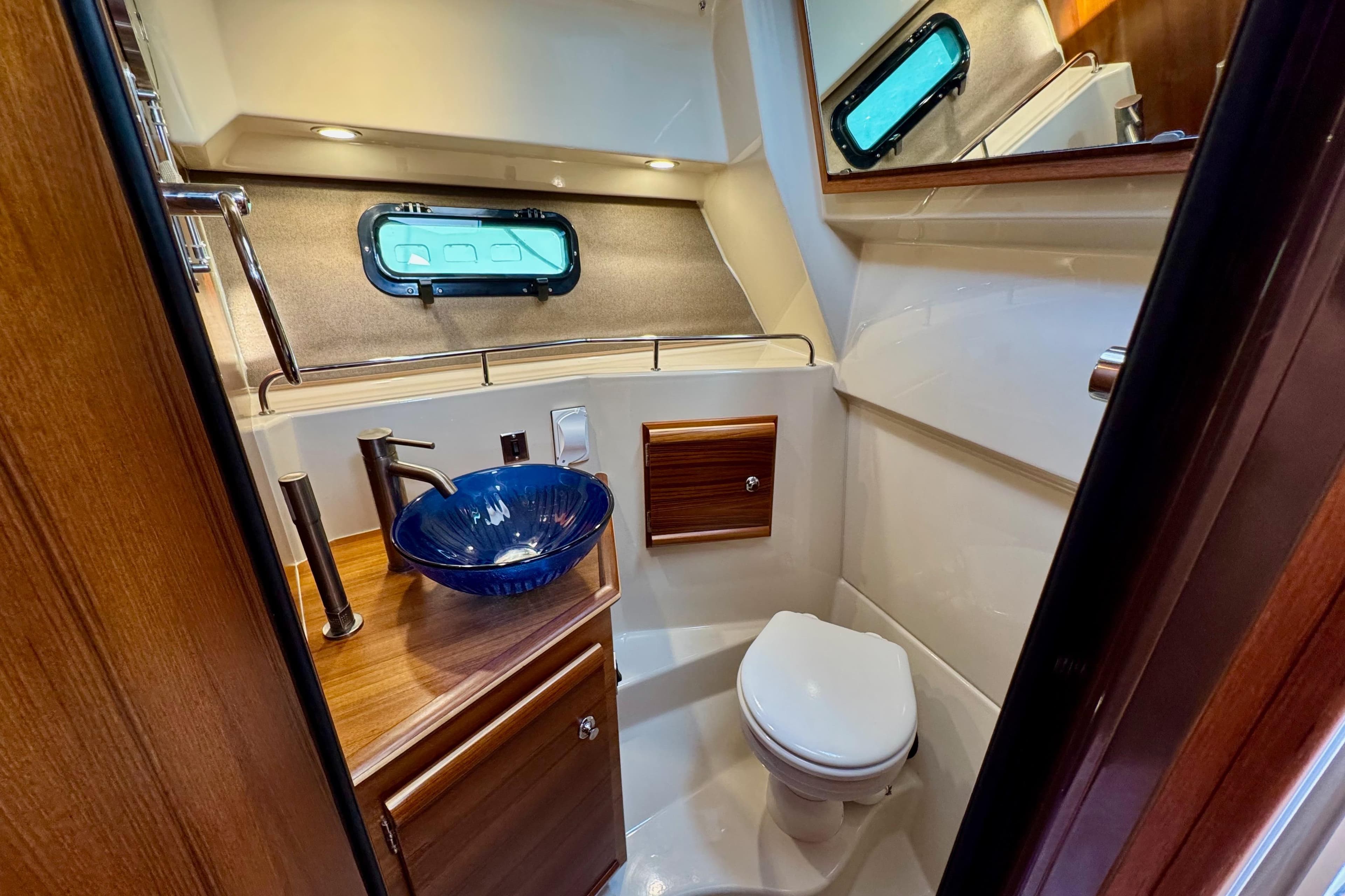 Luxurious 2024 Ranger Tugs R-27 bathroom with modern sink and elegant wood accents.