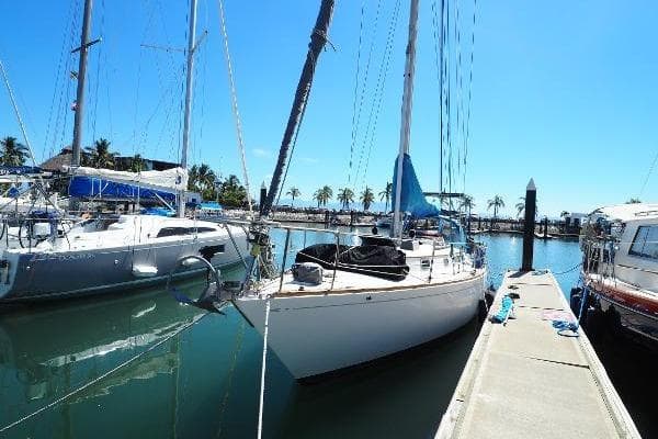 1982 Bristol 35.5 sailboat docked at a marina under clear blue skies.