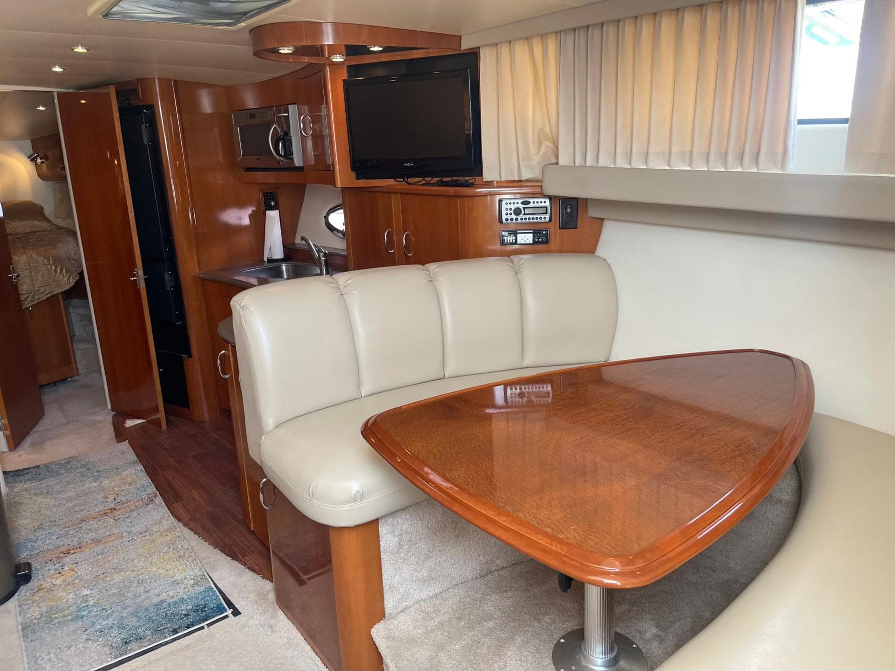 2006 Carver 36 Mariner interior with dining area, TV, and kitchenette.