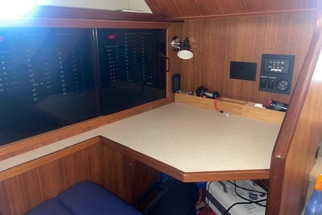 Navigation station in 2006 Nordic Tug 42 with control panels and wooden finish.
