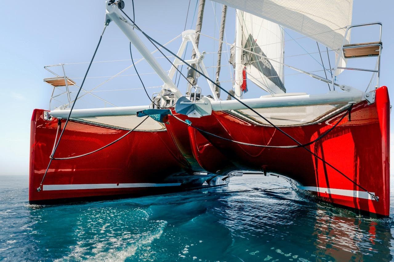 Red Privilege Signature 510 catamaran on calm water, year 2025.