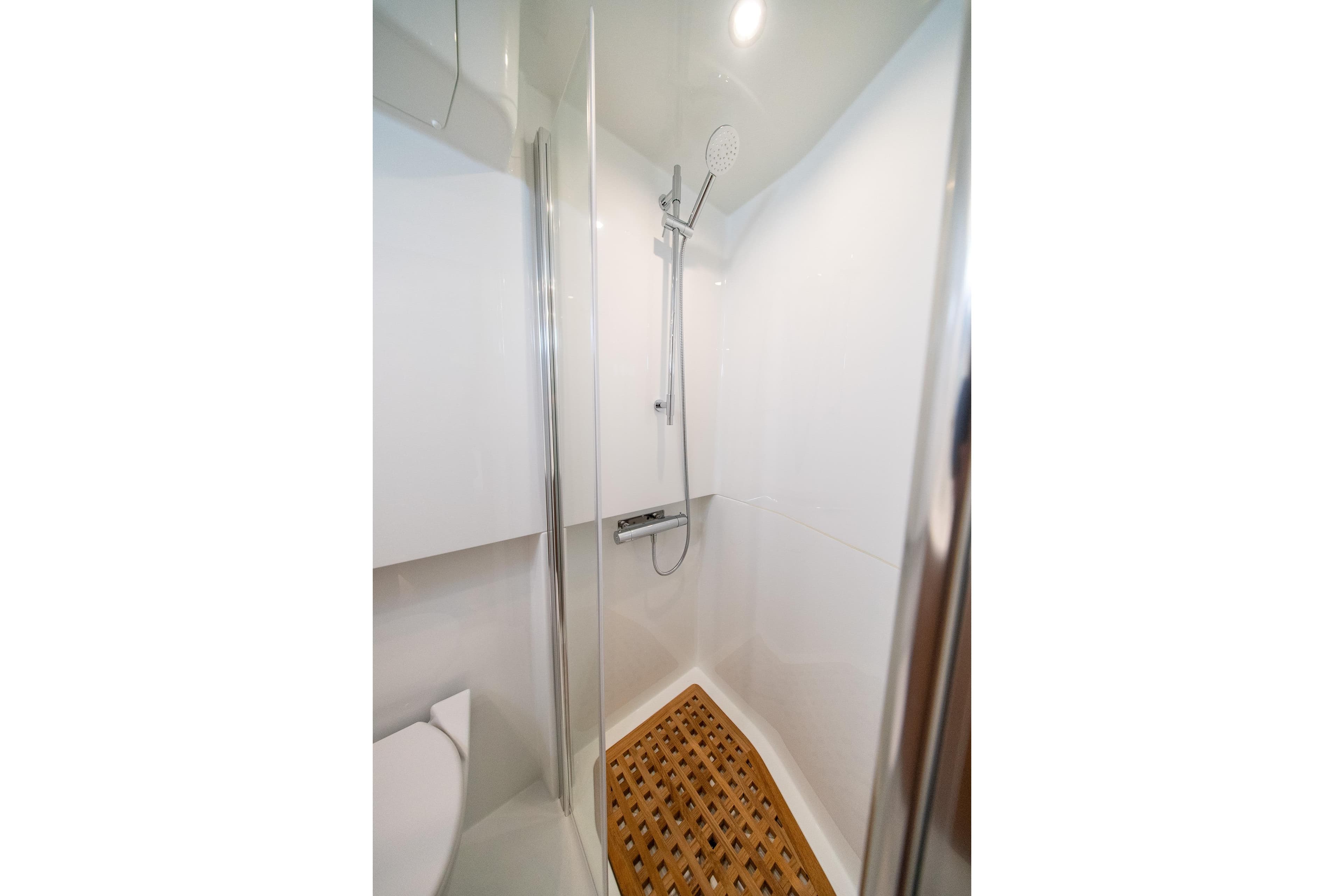 Modern shower in 2026 Targa 41 yacht with sleek design and wooden floor mat.