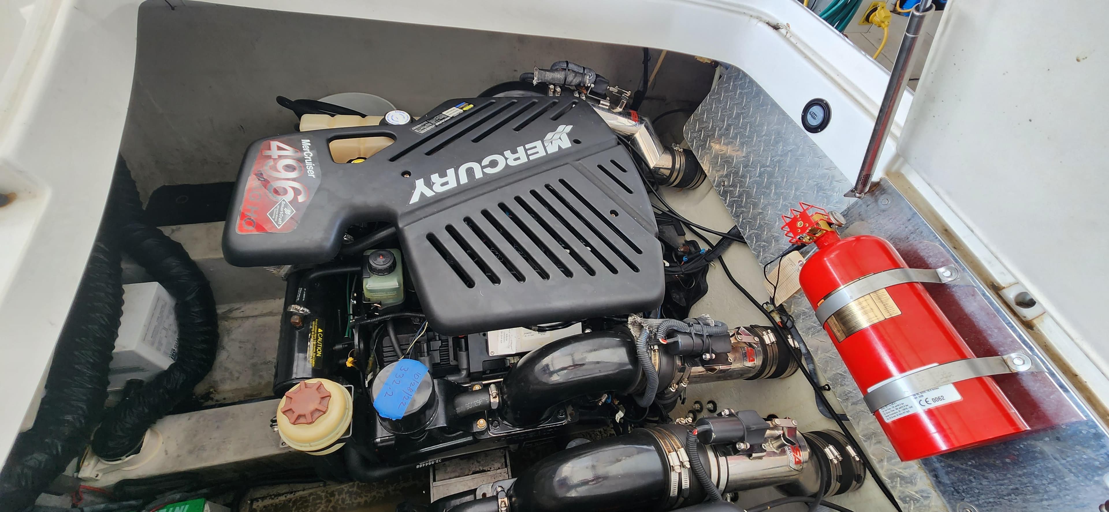 2007 Cobalt 343 engine compartment with Mercury engine and fire extinguisher.