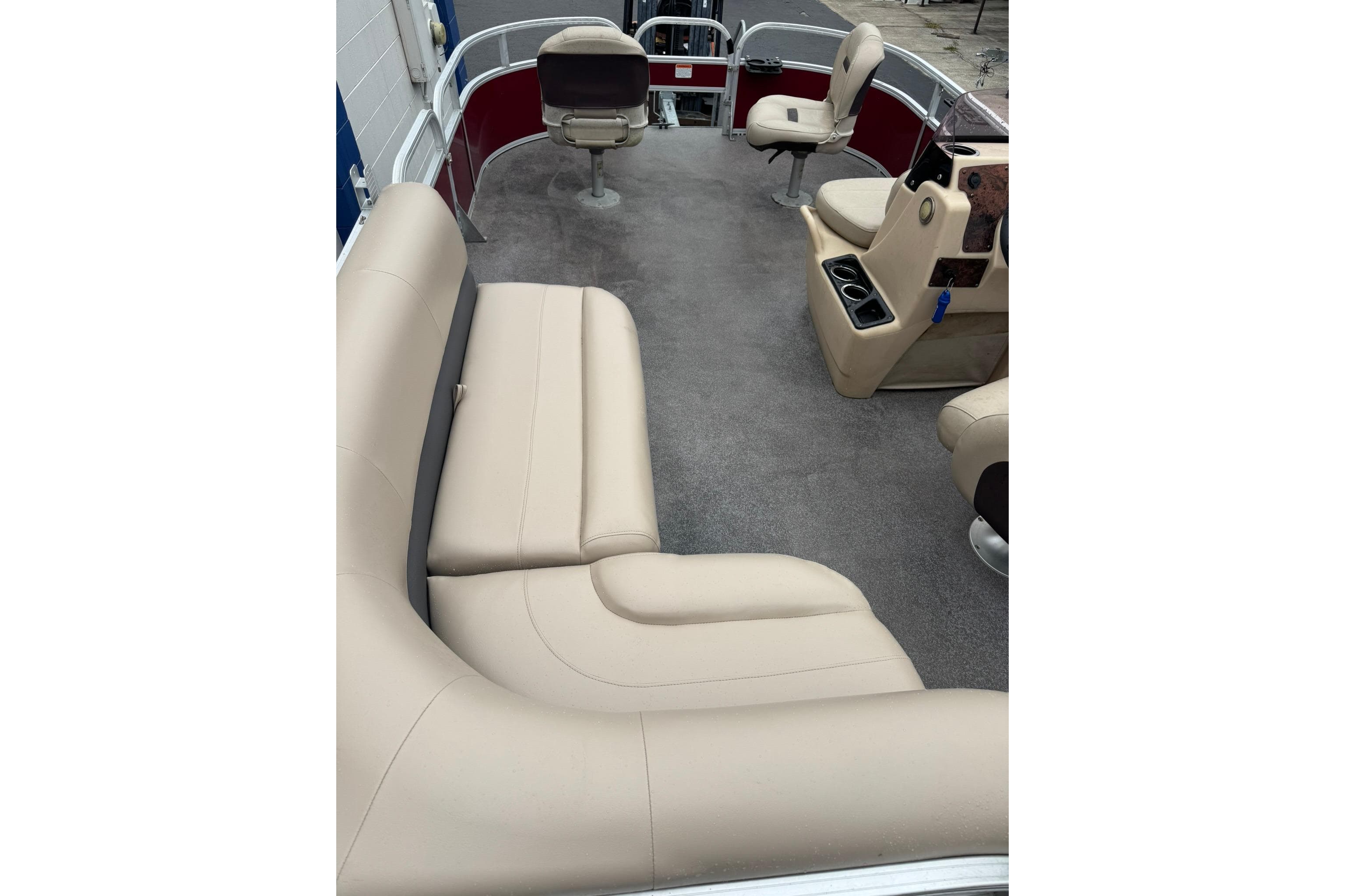 2019 Sun Tracker Bass Buggy 18 DLX interior with beige seating and carpeted floor.