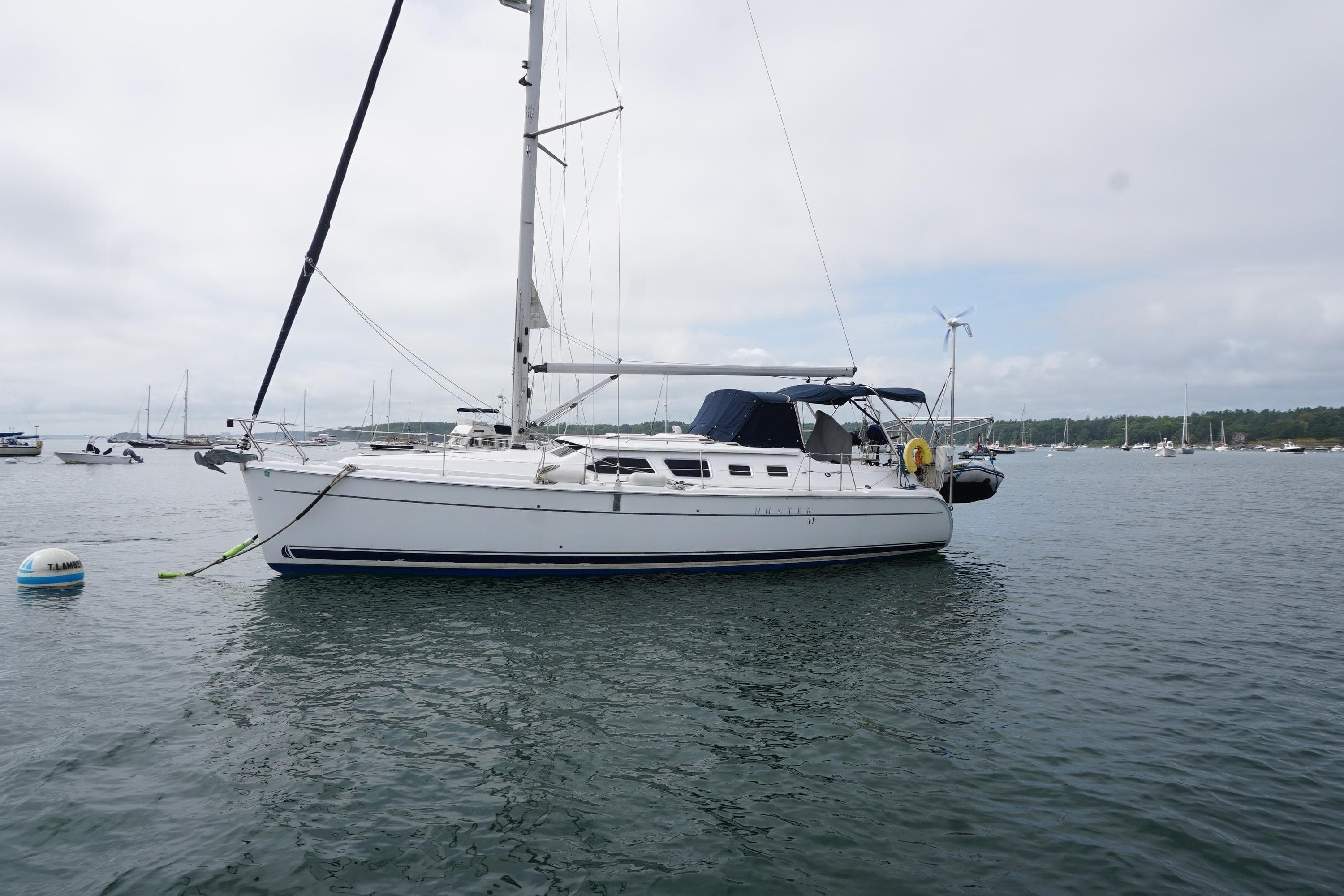 2006 Hunter 41 Deck Salon sailboat anchored in a calm harbor.