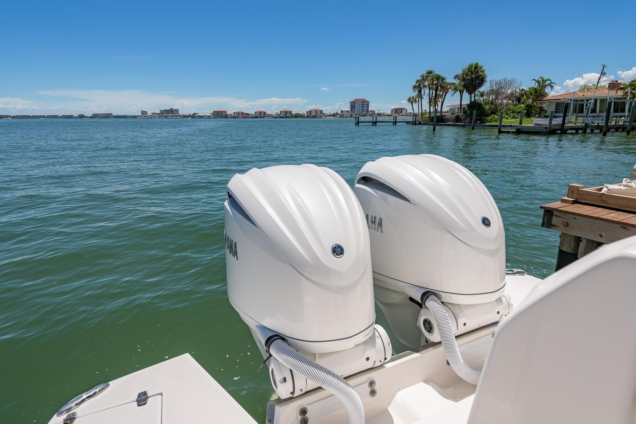 2024 Regal 33 SAV boat with twin Yamaha outboard engines on a sunny waterfront.