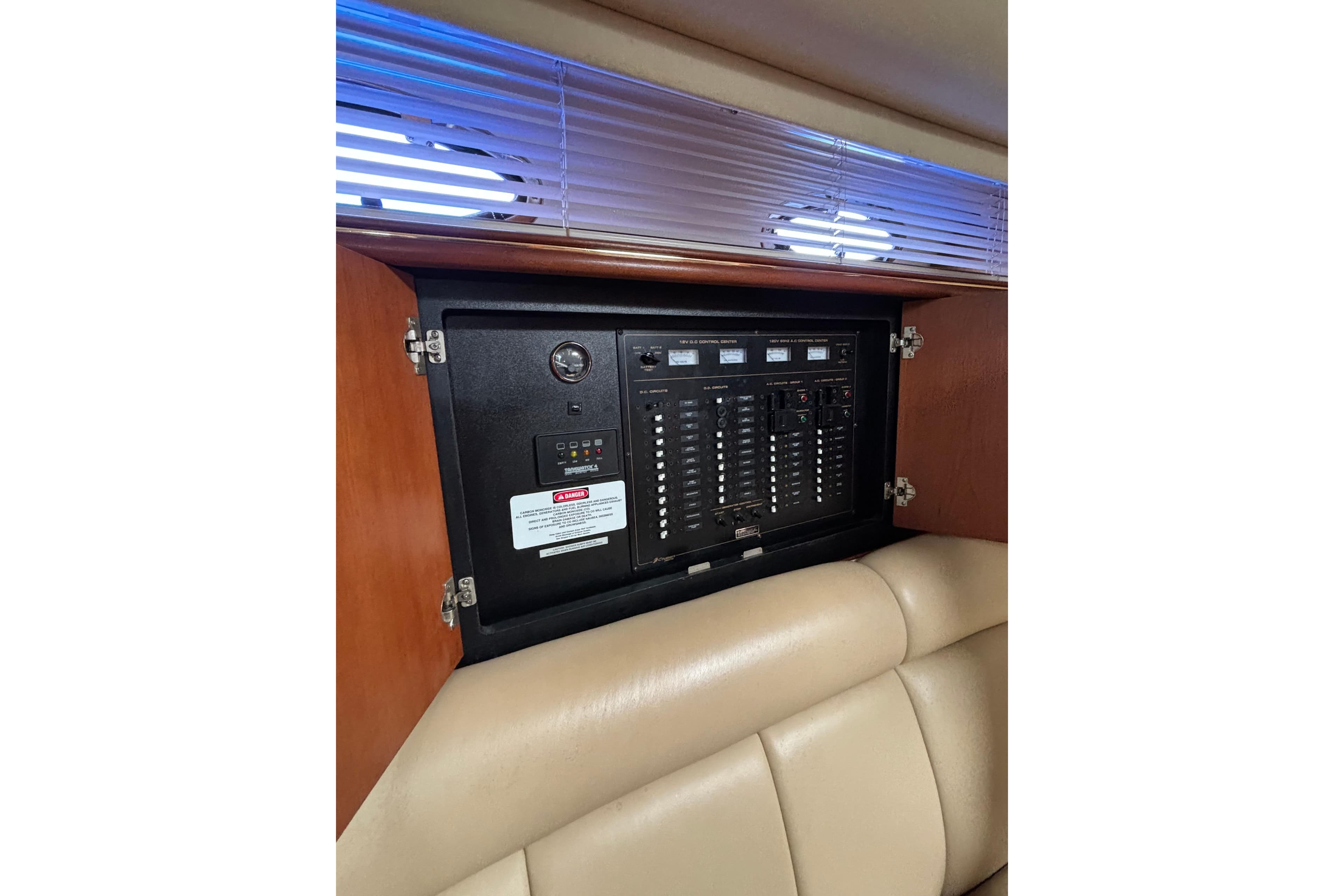 Electrical panel inside a 2000 Cruisers 3870 yacht, featuring switches and gauges.
