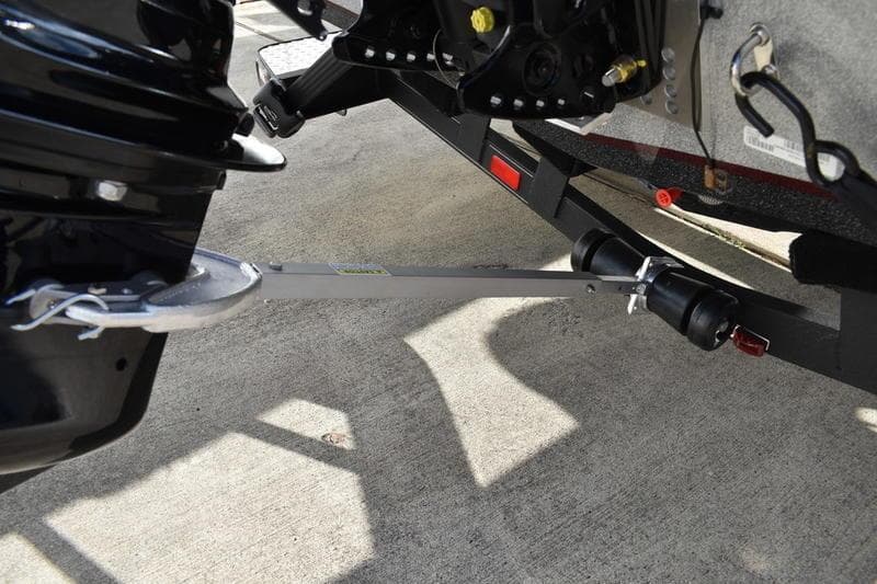 2026 Triton 179 TrX boat trailer with motor support on concrete surface.