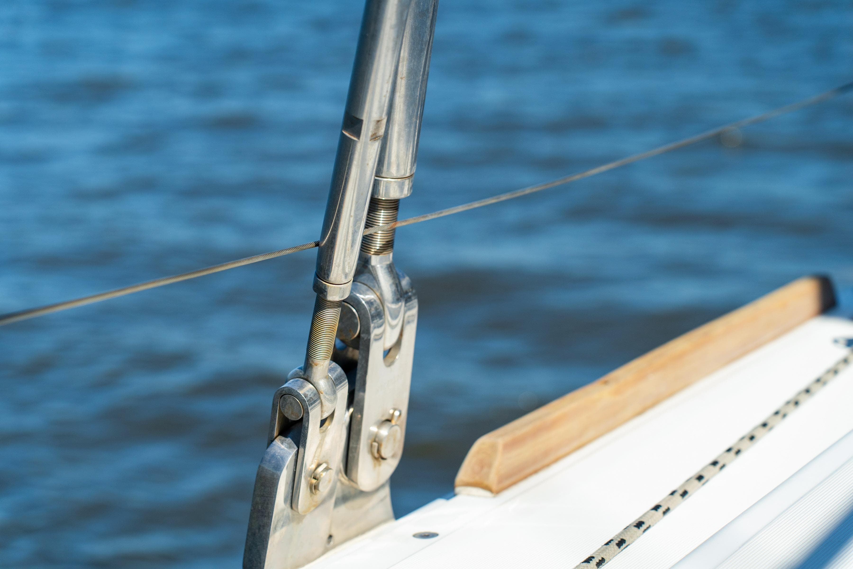 Close-up of a 2012 Lagoon 560 yacht's rigging against a blue water backdrop.