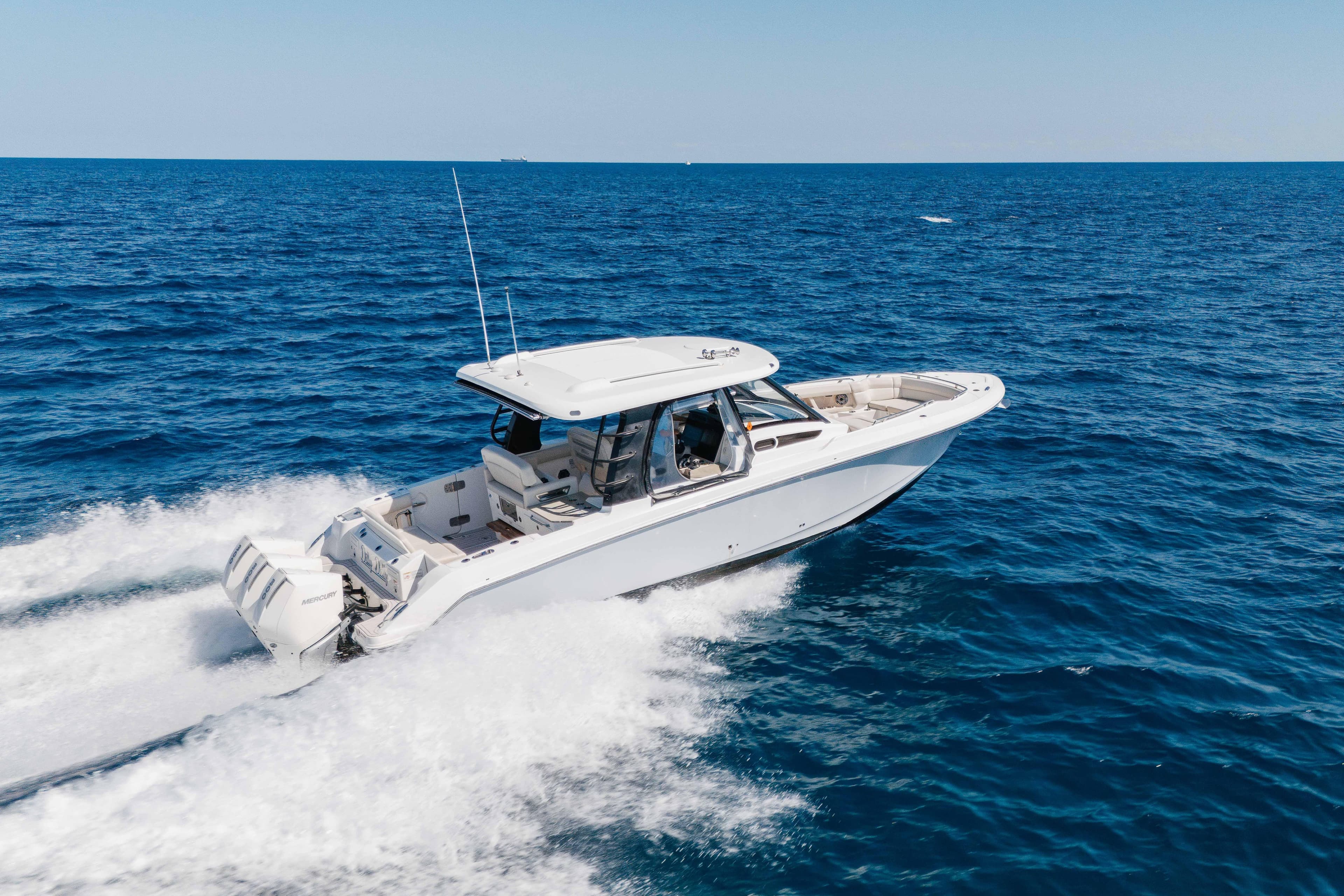 2021 Boston Whaler 350 Realm cruising on open blue ocean waters.