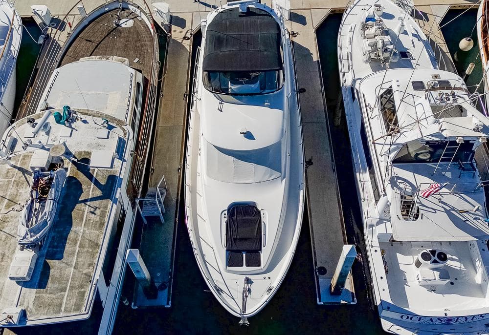 Aerial view of a 2008 Meridian 580 Pilothouse yacht docked between two boats.