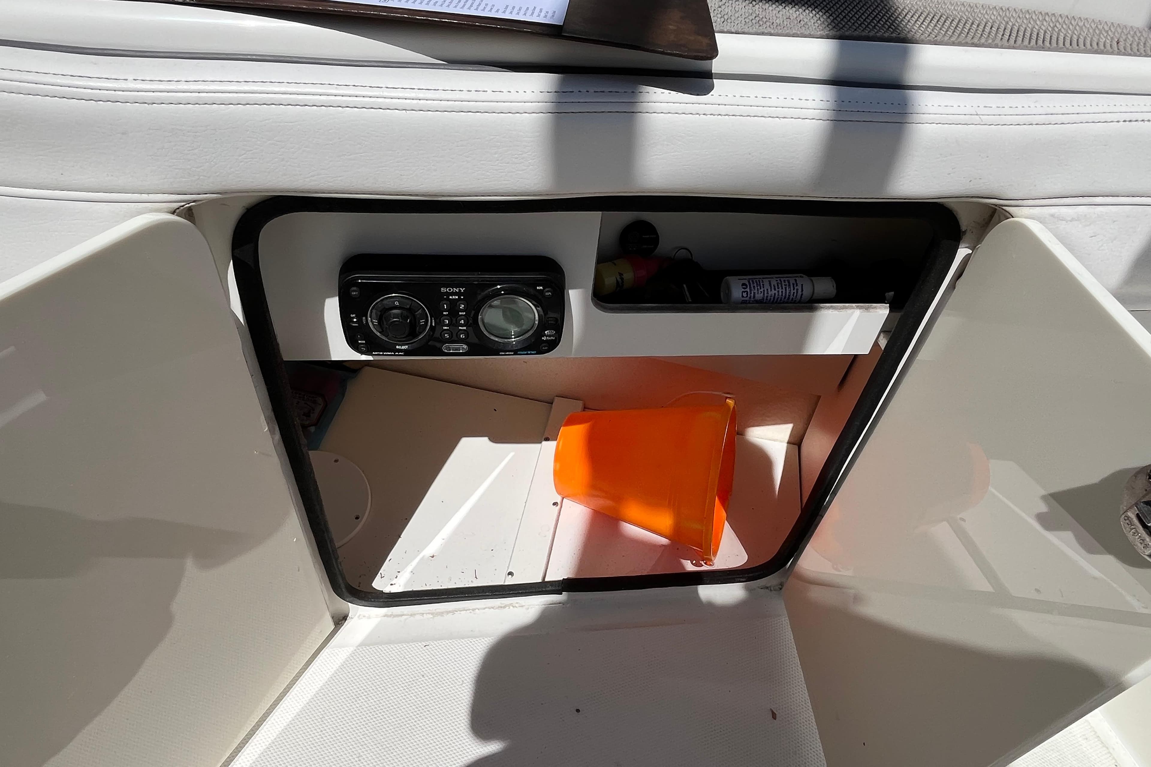 2011 Sea Ray 260 Sundeck storage compartment with Sony stereo and safety equipment.